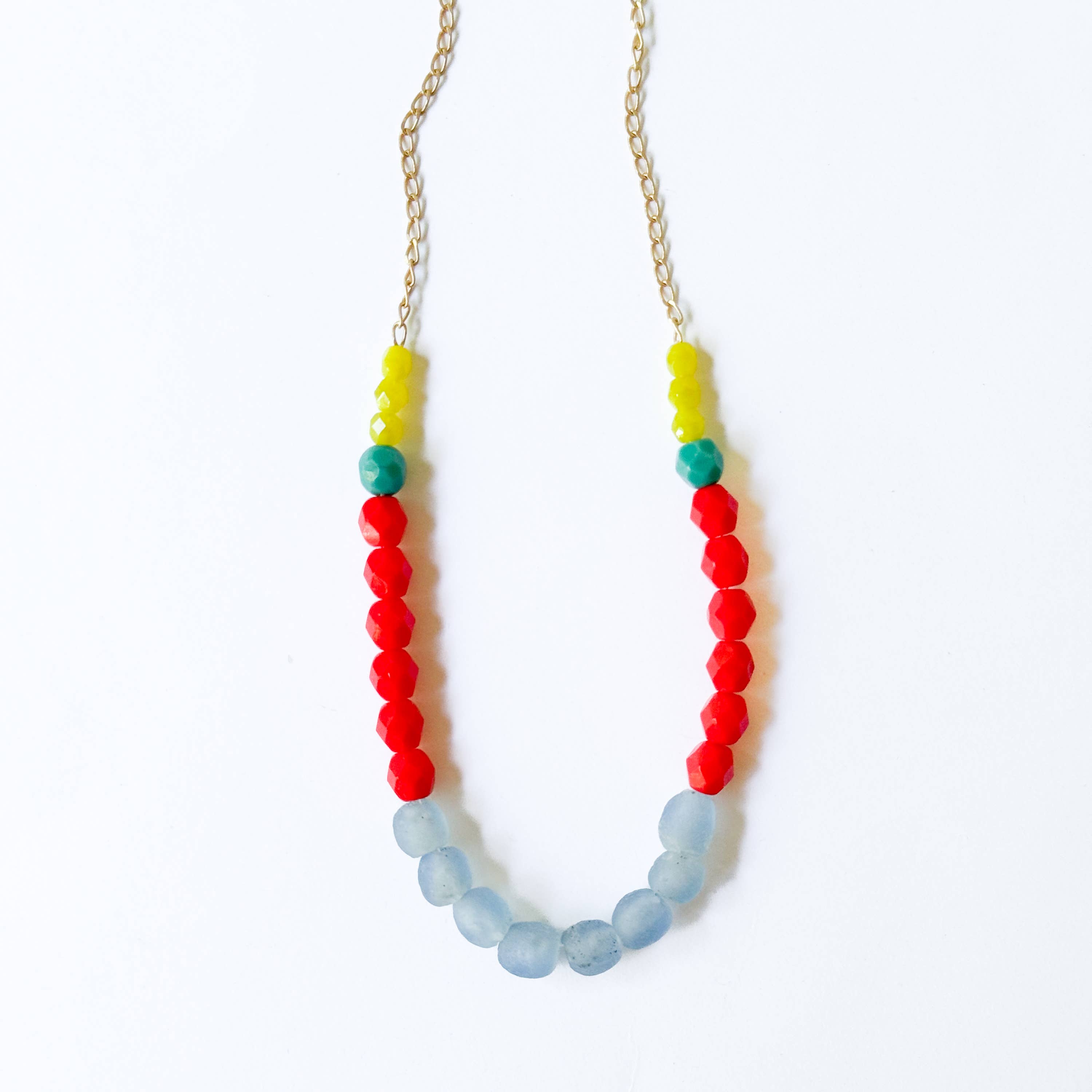 Multicolor Recycled African Glass And Mixed Bead Necklace with yellow, red, green, and blue beads and a gold chain detail