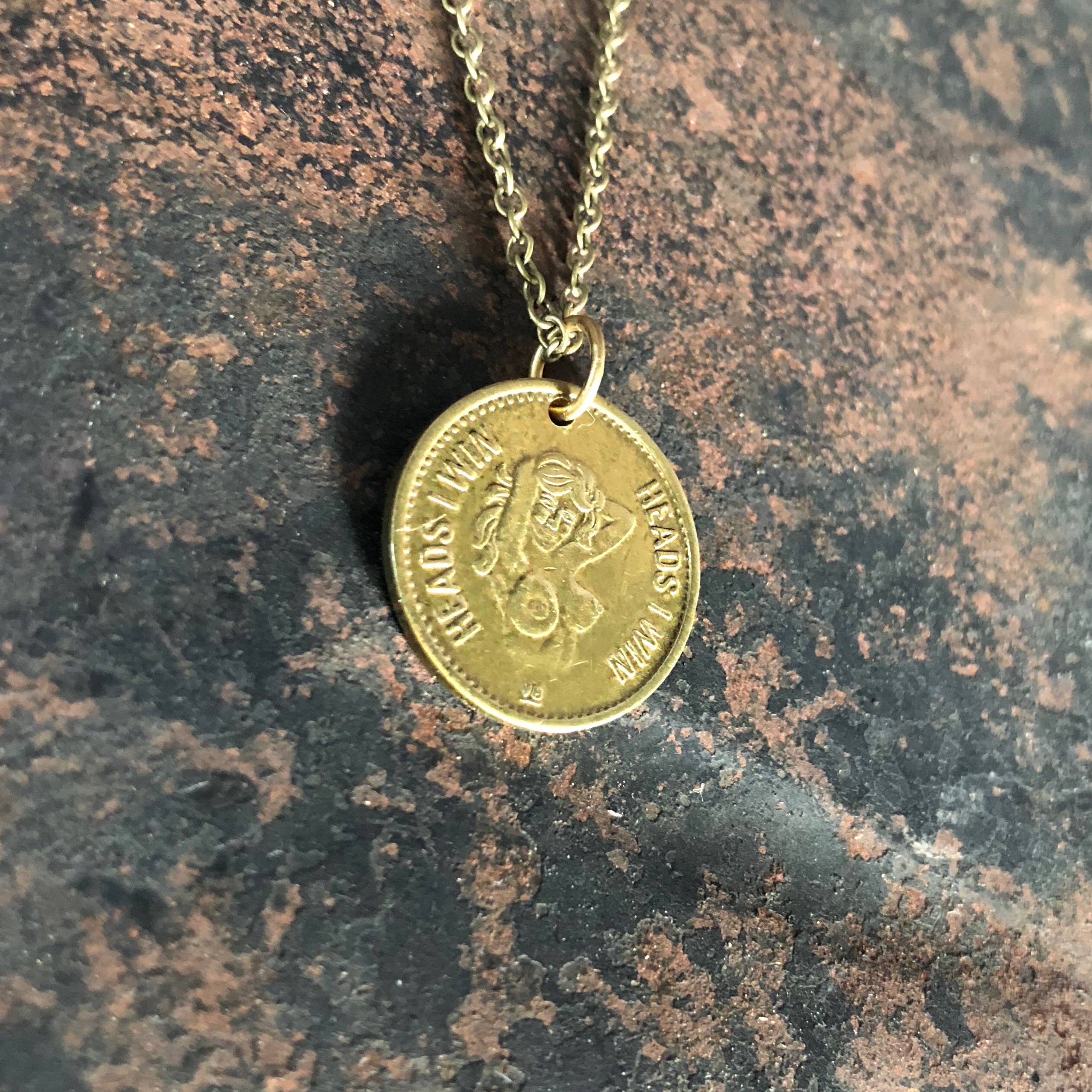The ASTALI Vintage Heads & Tails Peepshow Token Necklace features a coin pendant with HEADS and a womans profile on an antique brass chain—unique collectible jewelry with nostalgic vintage charm.