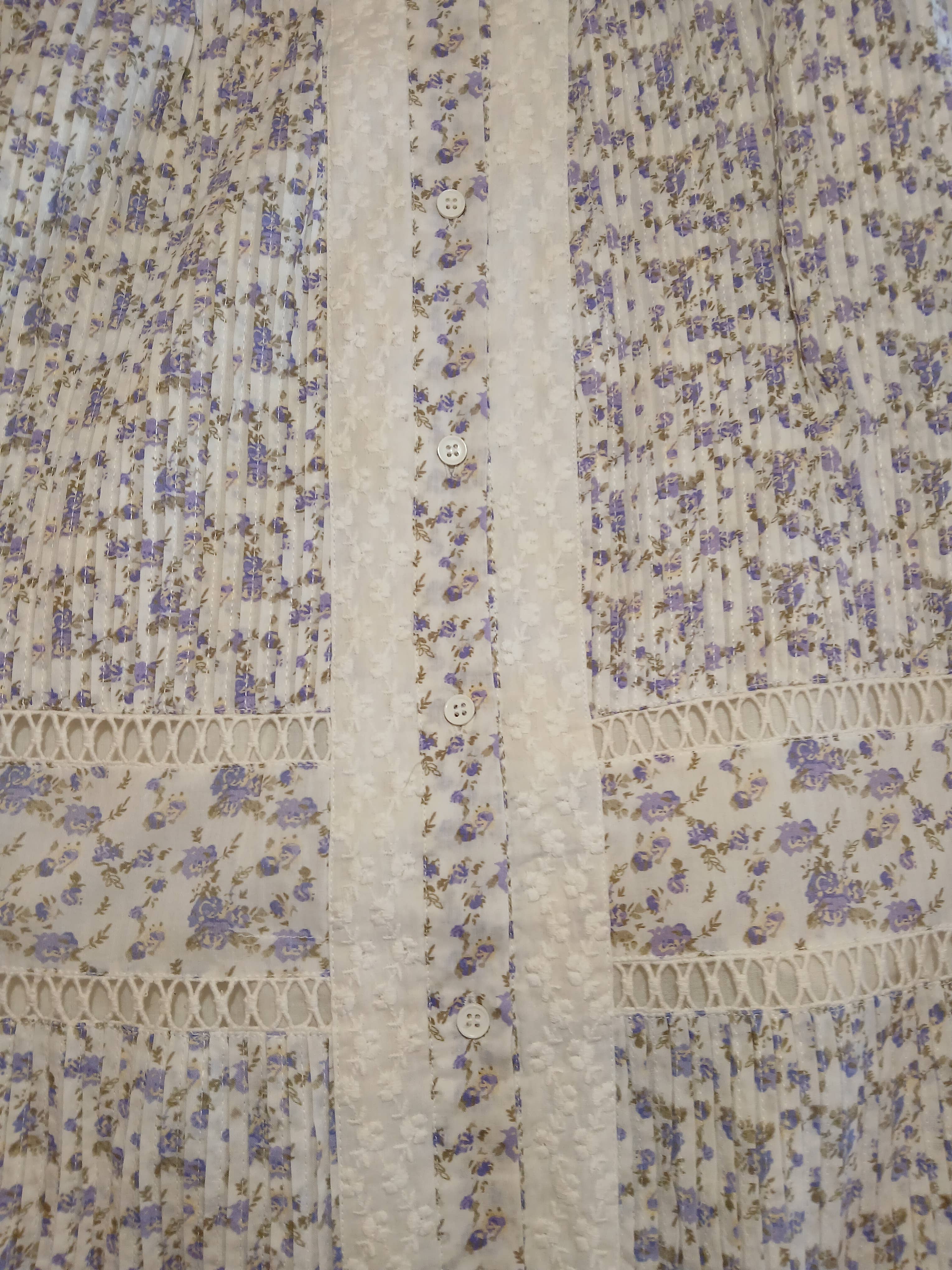 Close-up of Holly Dress delicate floral pattern with white buttons and textured lace trim detailing