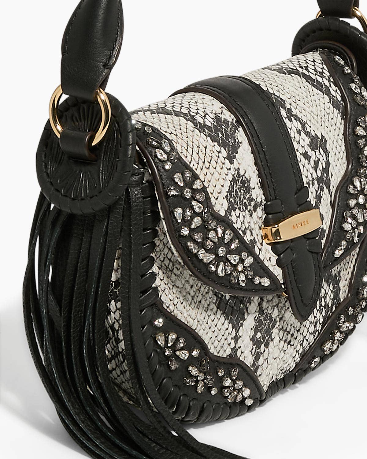 Willow Novelty Mini Crossbody with black and white snake print, studded embellishments, and leather tassel detailing
