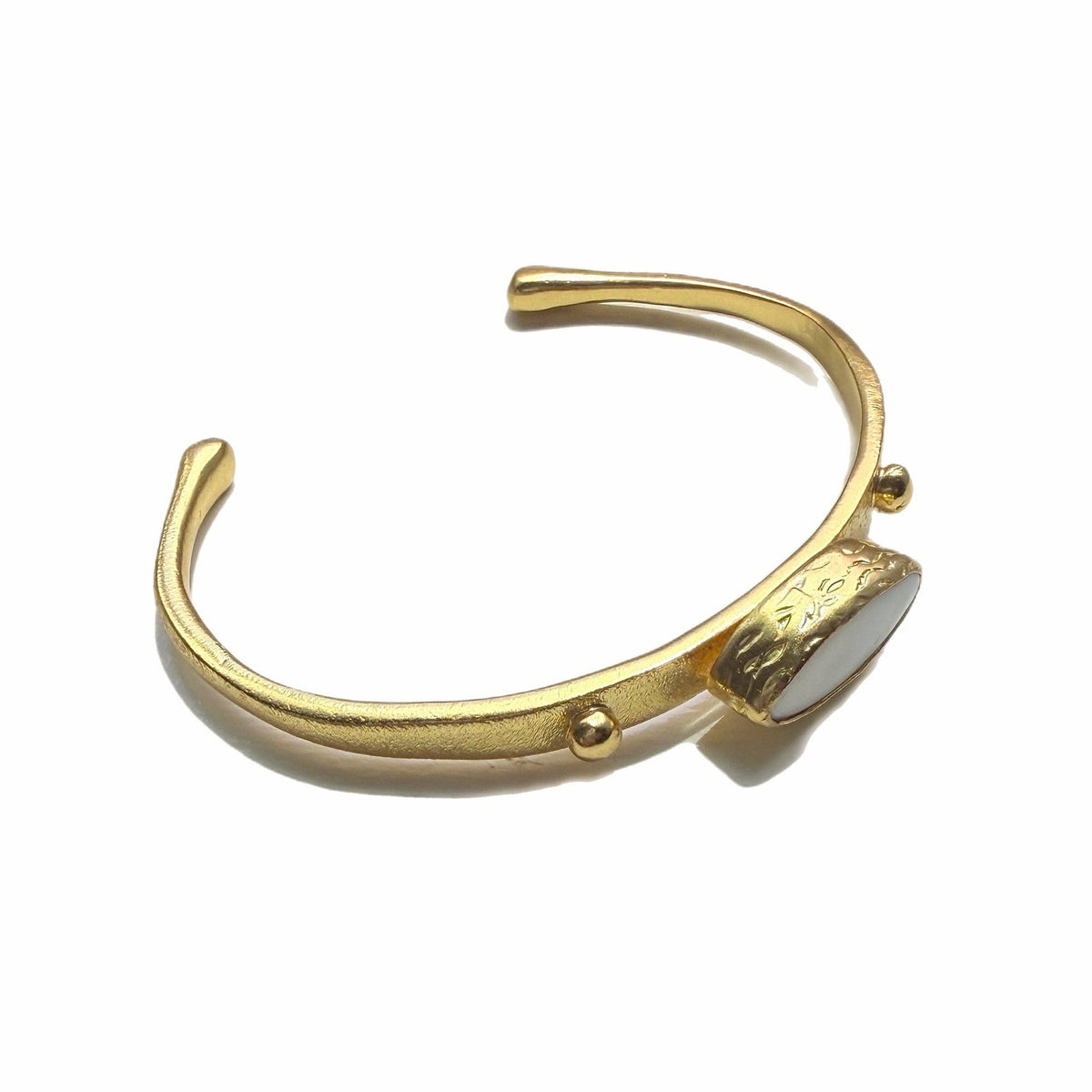 Zeynab Mother of Pearl Cuff Bracelet with a gold tone band and mother of pearl accent