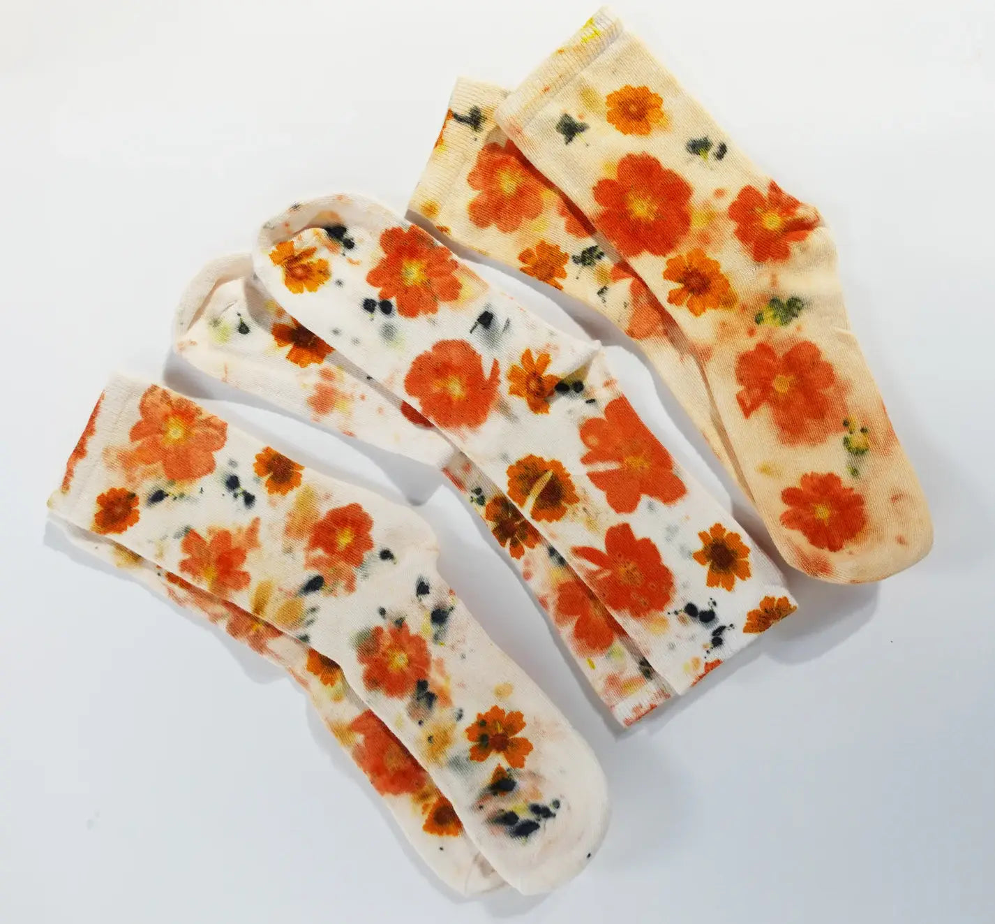 Two pairs of Flower Power Cotton Crew Sock with bright orange floral patterns on soft cotton fabric