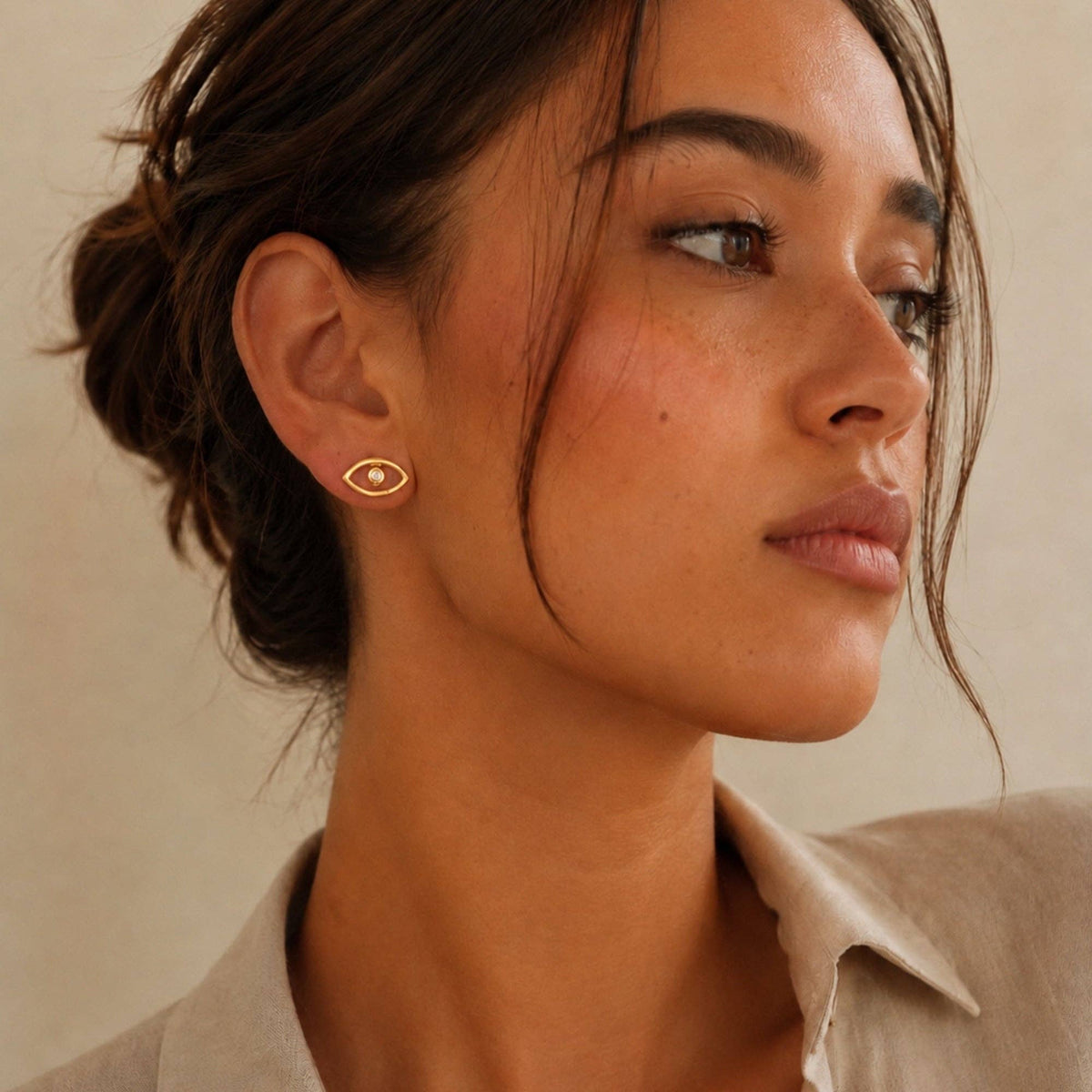 Evil Eye Silhouette Studs CZ worn as a gold eye shaped stud earring