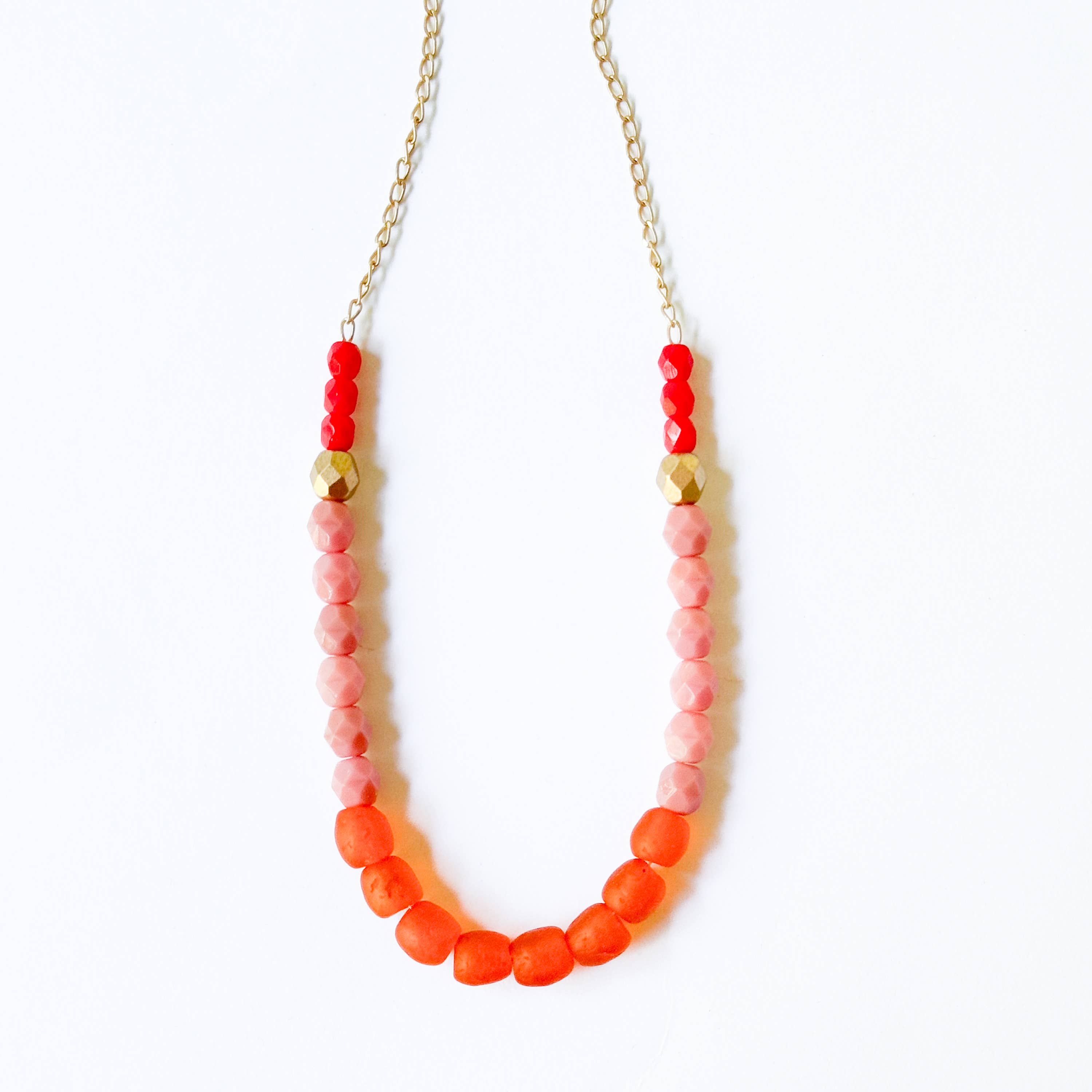 Multicolor Recycled African Glass And Mixed Bead Necklace with red, pink, and gold beads on a gold chain