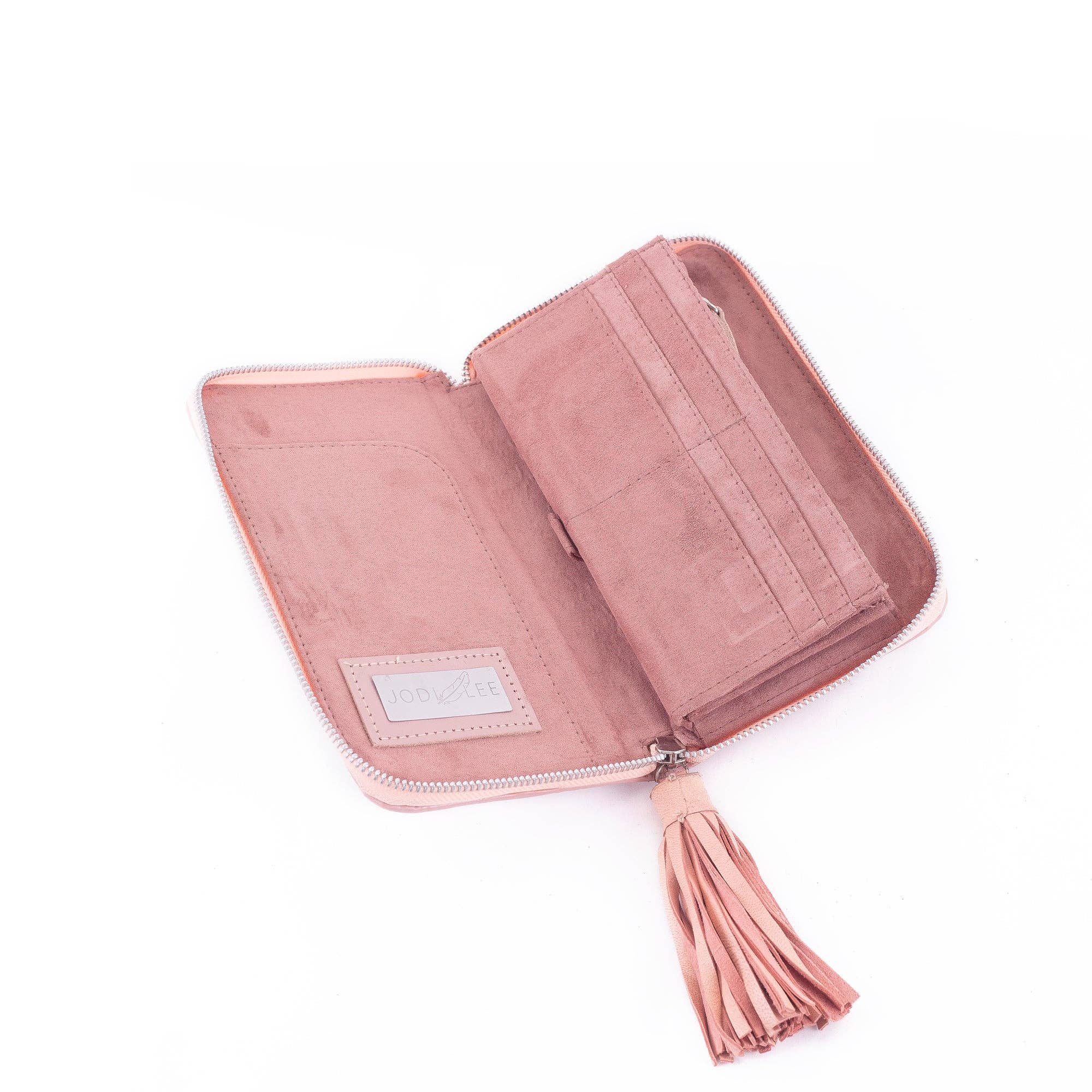 The Wild Waratah Wallet Pink by Jodi Lee is hand-tooled pink suede with a zipper and tassel, featuring card slots, a pocket, genuine Rose Quartz gemstone accents, and an interior label reading Jodi Lee.