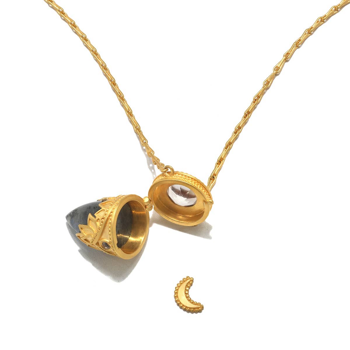The Satya Jewelry Guiding Spirit Labradorite Feather Locket Necklace (18") features a crown-like gold locket that opens to reveal a crescent charm, pairing elegance and spirituality on a textured chain.
