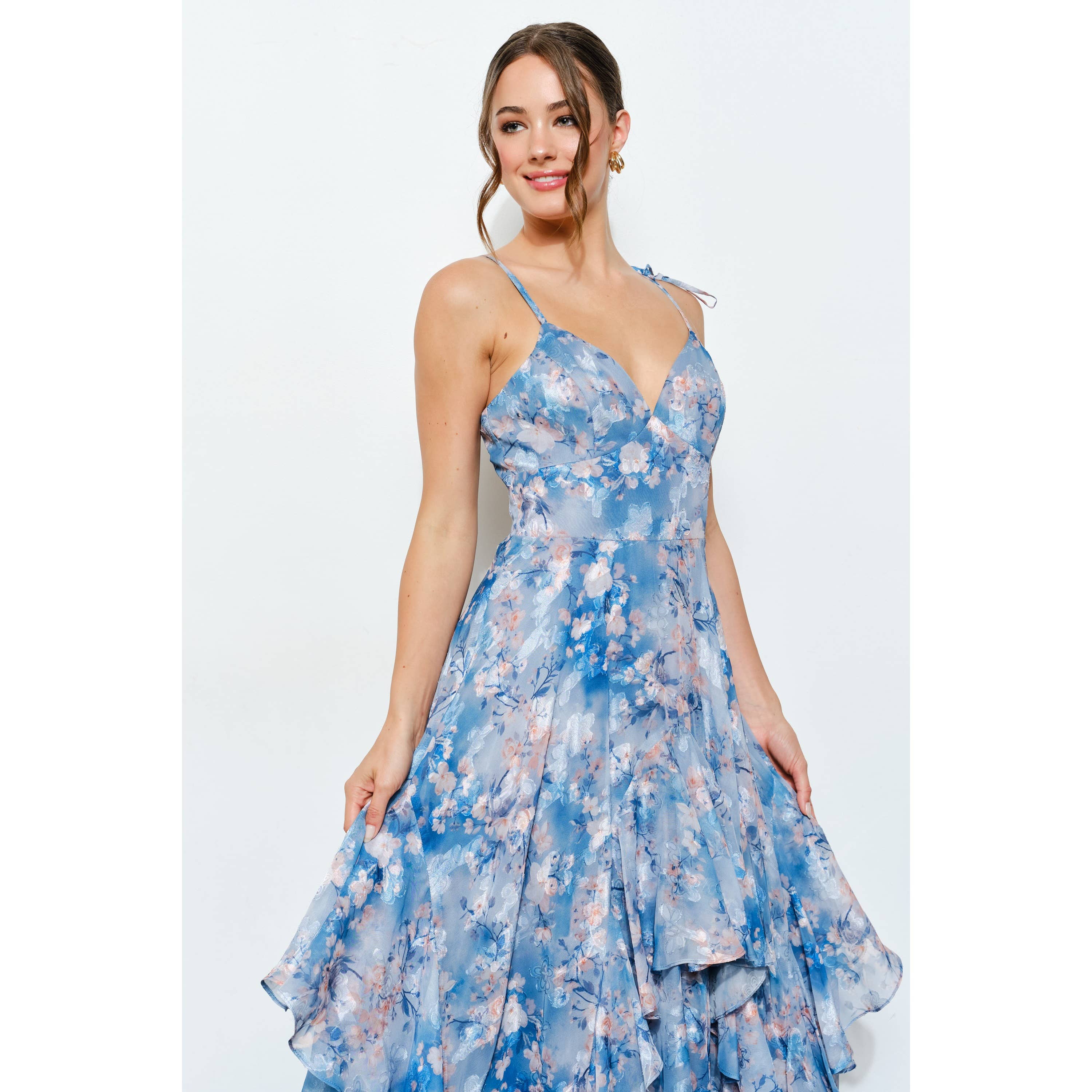 Woman wearing Romantic Floral Sweetheart Ruffled Maxi Dress with blue and pink floral patterns, smiling confidently