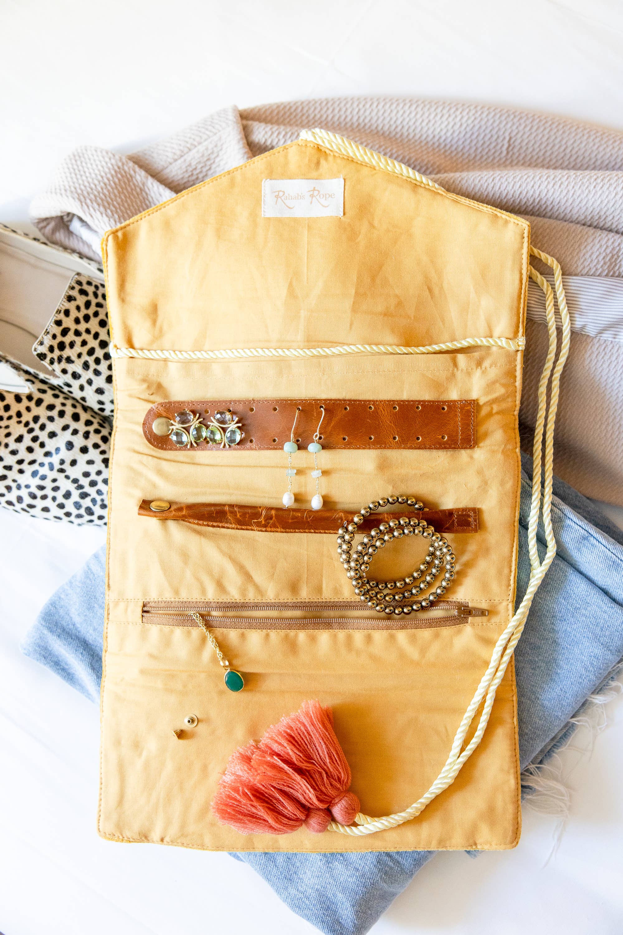 Embroidered Velvet Jewelry Organizer-Mustard with earrings, bracelets, and necklace on soft fabric backdrop