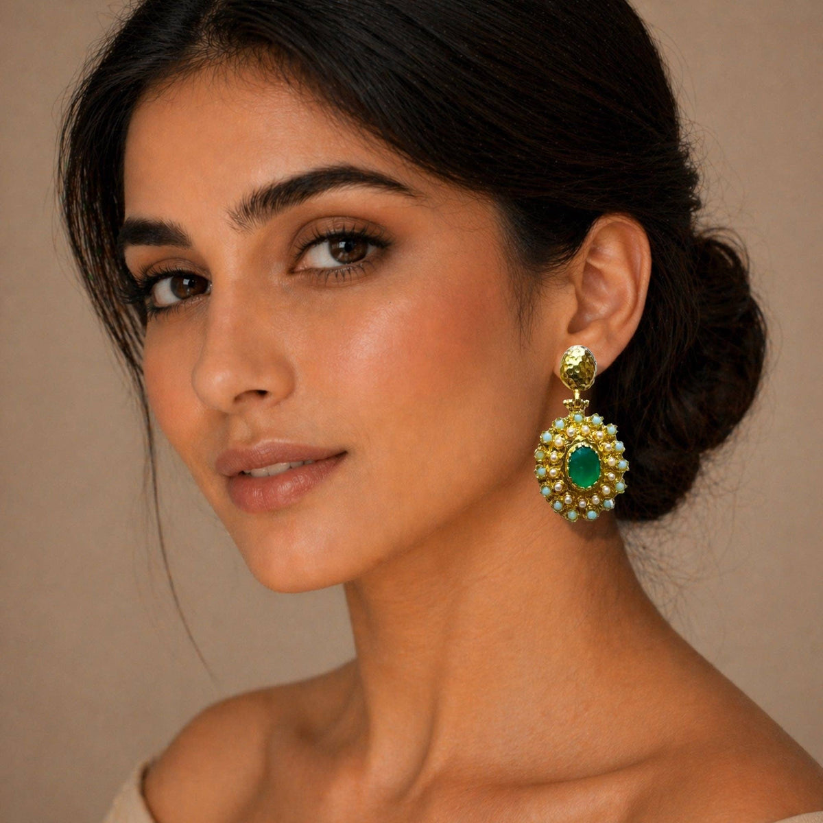 Gulya Emerald and Pearl Pendant Earrings with green emeralds and pearl details worn by a model
