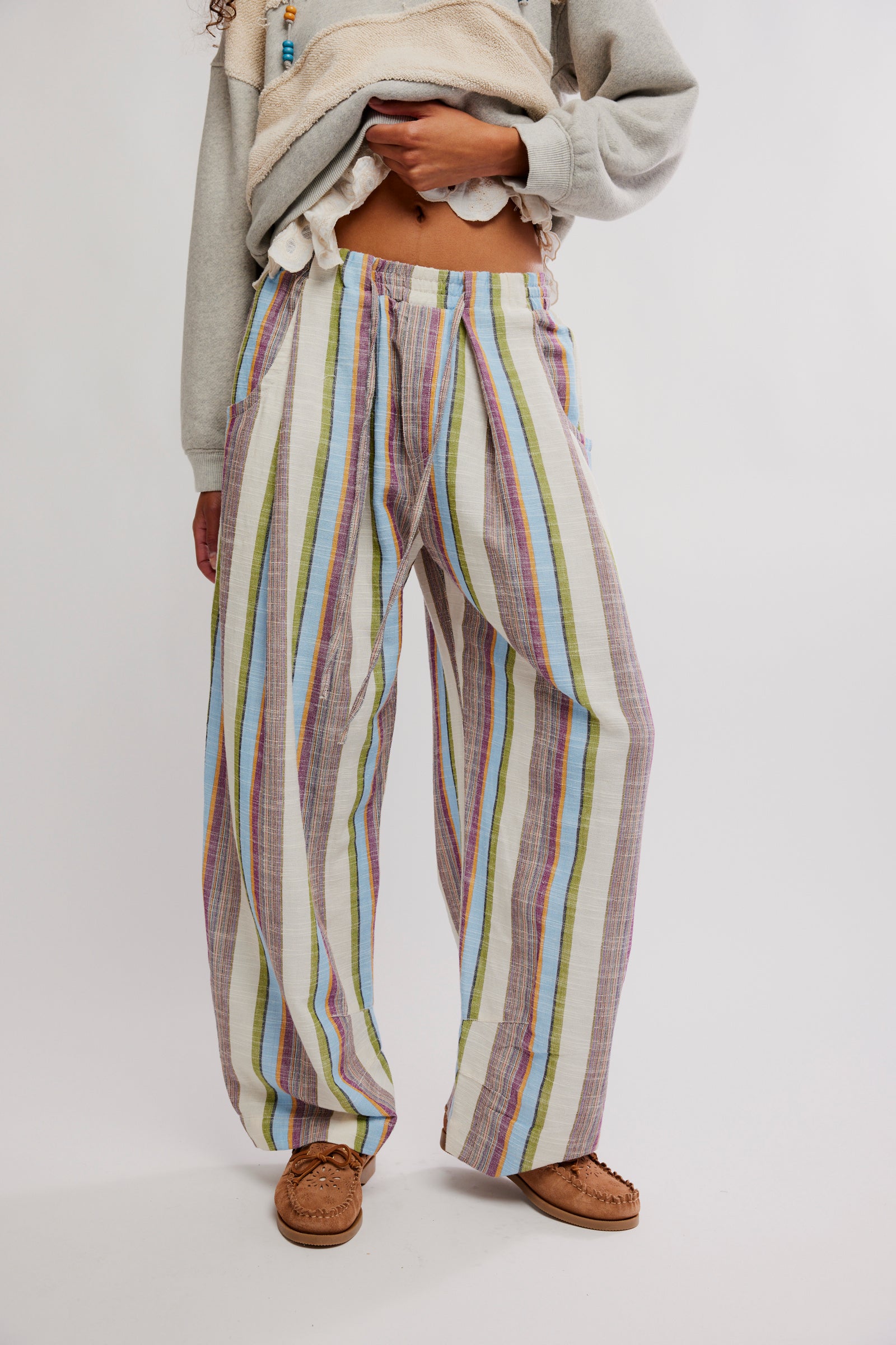 Woman wearing Free People Chambers Laid Back Stripe Pull-On Pant with multicolor vertical stripes and relaxed fit