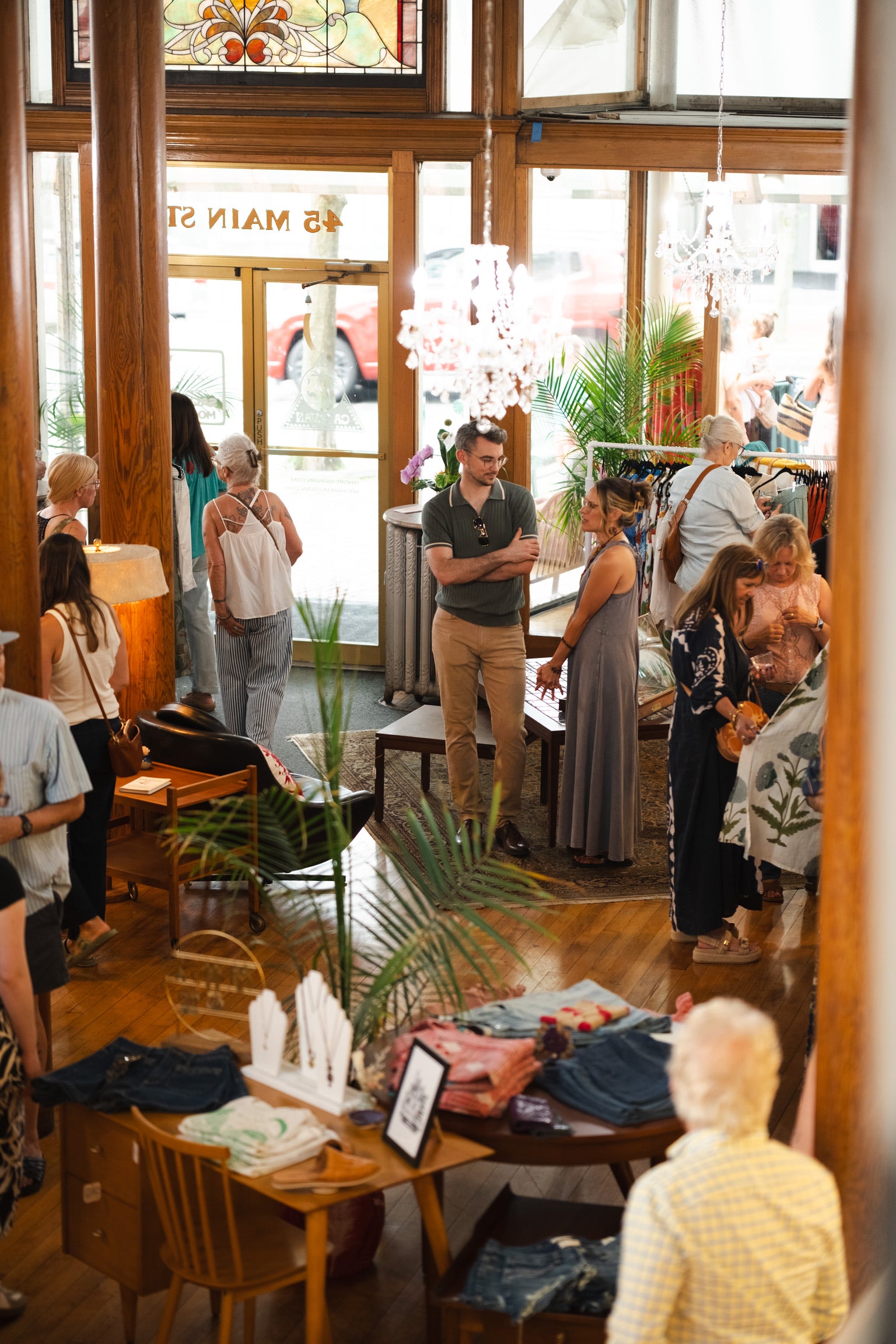 People in a casual indoor setting with wooden furniture and decor.