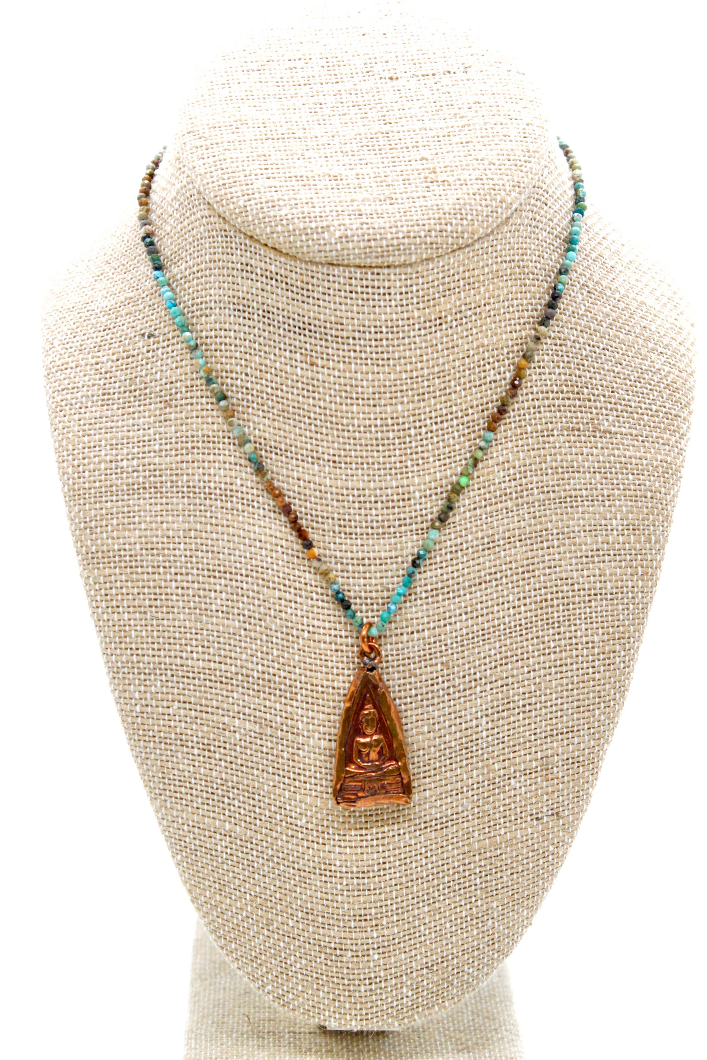 Buddha Necklace 123 - Gradient Faceted Turquoise Stone Necklace with bronze Buddha pendant on woven display bust