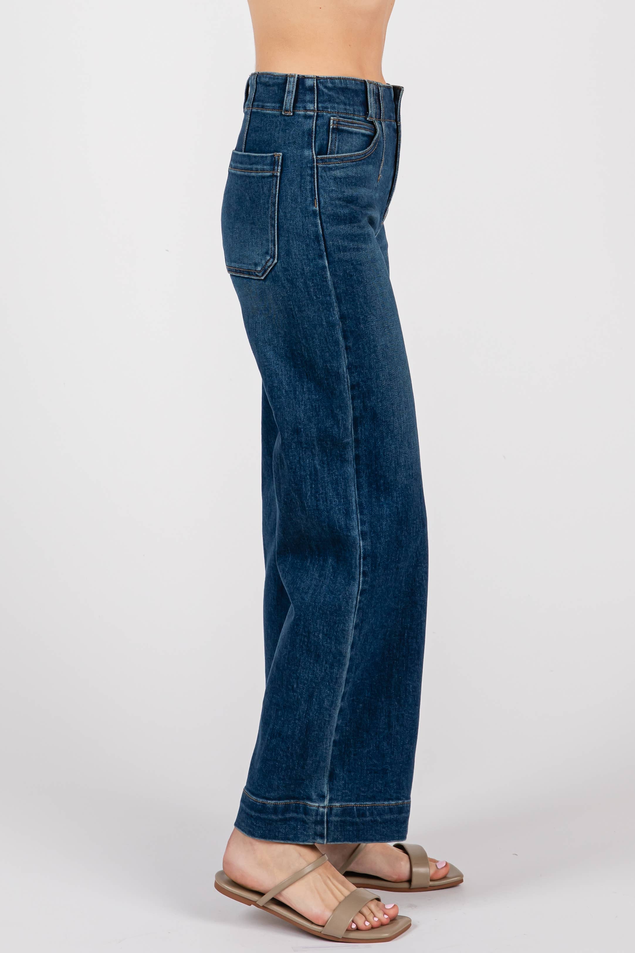 A person stands sideways against a plain white background, wearing L.T.J Letter to Juliet Dart Detail Wide Crop Jeans in dark blue with beige open-toe sandals.