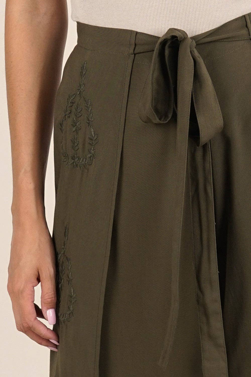 Close-up of olive green Boho Beach Light Weight Wrap Pant featuring delicate embroidered details and a tied waist wrap.