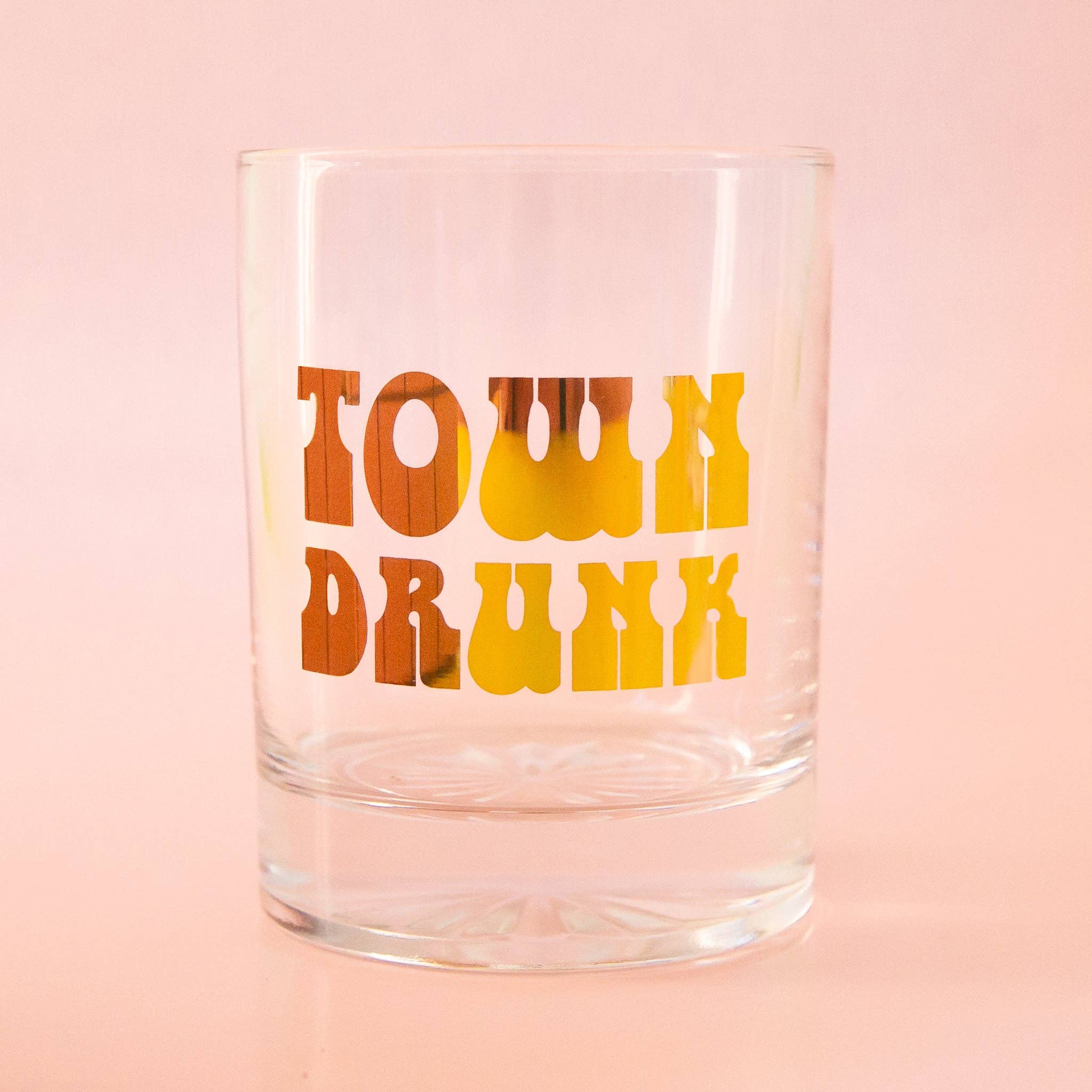 Clear glass tumbler with bold retro font reading Town Drunk in warm gold tones Town Drunk Tumbler | Gold