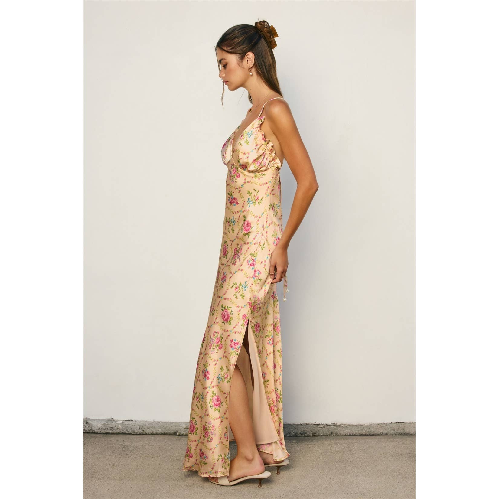 Side view of woman wearing Eternal Afternoon Ruffled Triangle Bust Maxi Dress with floral pattern and a slit detail
