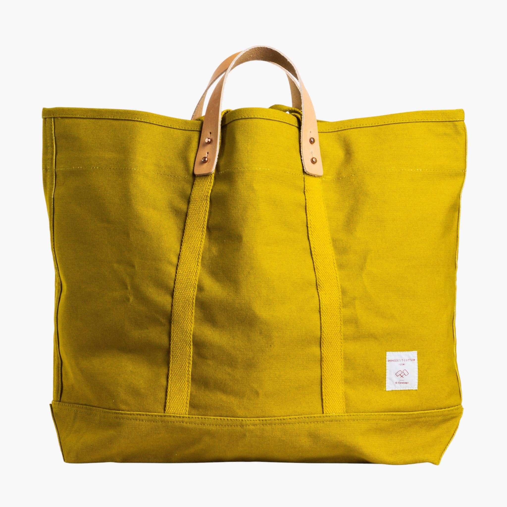 Yellow tote bag with leather handles on a white background