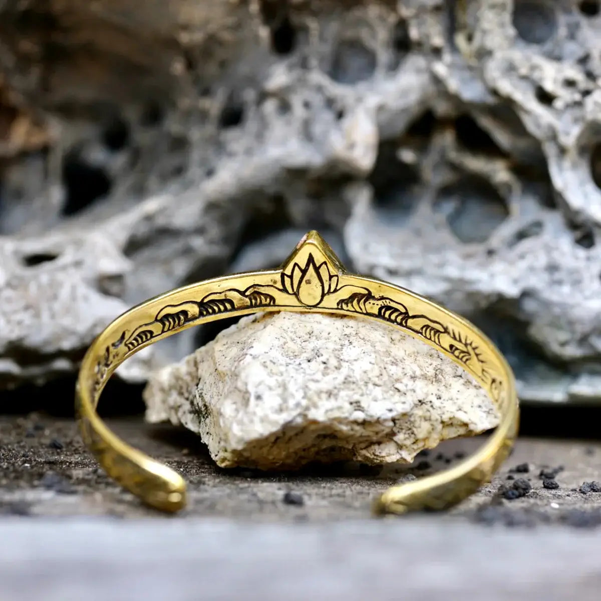 Hold Space Cuff features an artisan brass band with delicate engraved floral designs and a polished finish.