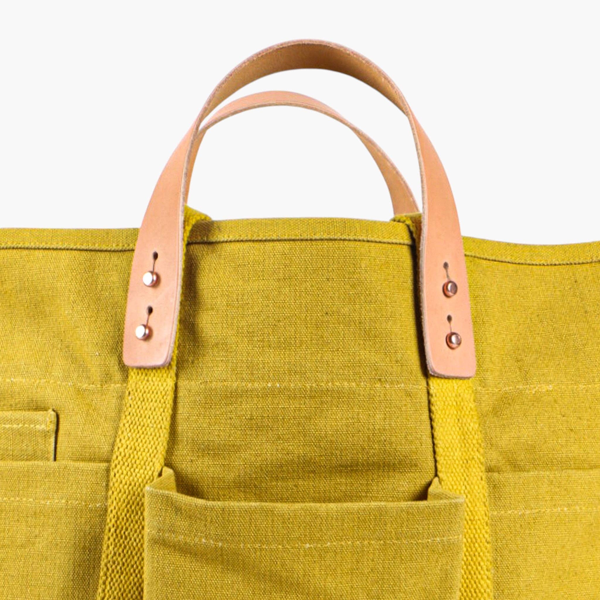 Construction Tote | Chartreuse canvas tote with leather handles and multiple exterior pockets for easy organization