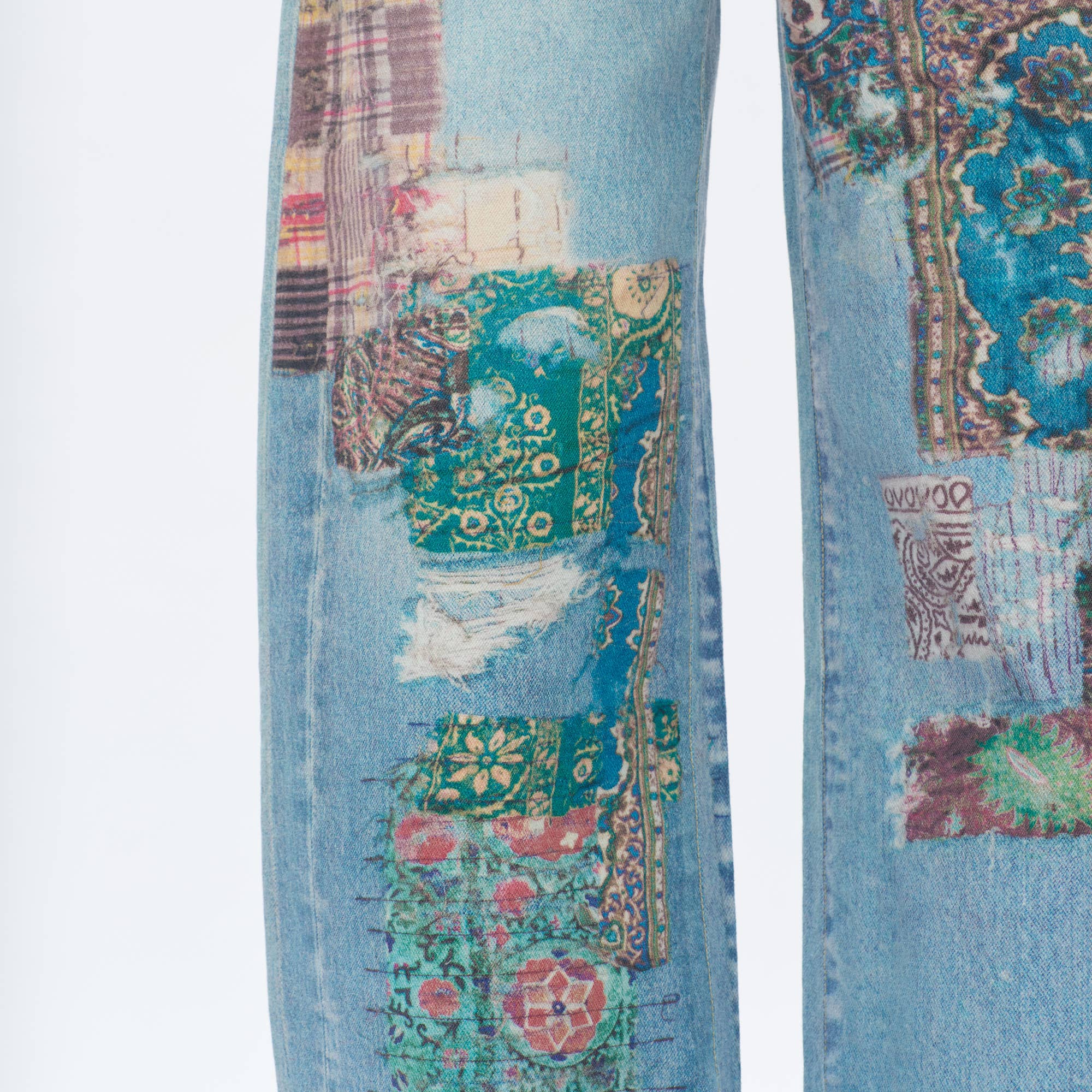 Close-up of BAYEAS Light Blue Patch Pattern High-Rise Barrel Jeans, featuring comfort stretch denim with colorful patchwork in green, teal, red, and purple, visible stitching, and frayed edges for a bold look.