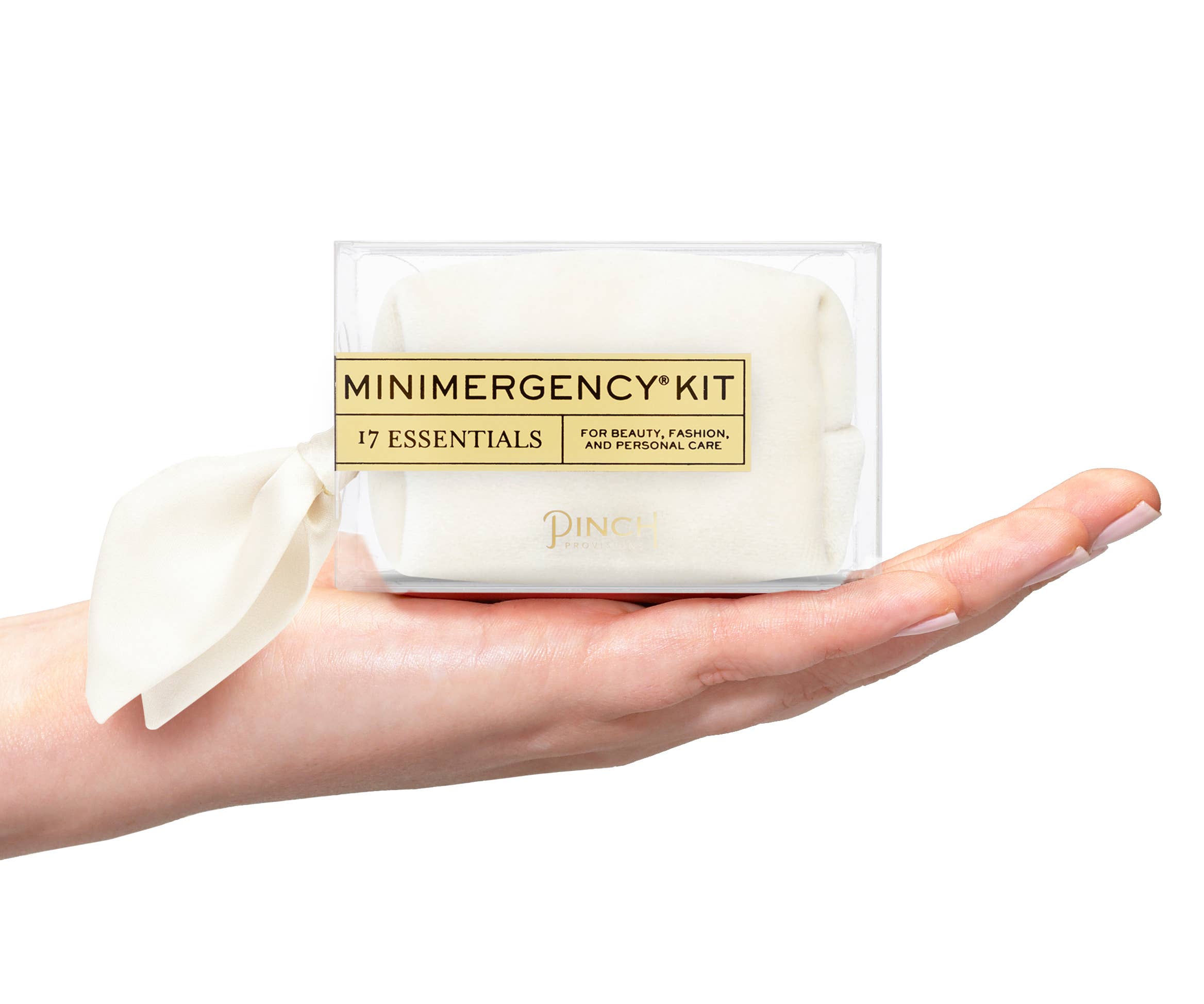Velvet Scarf Minimergency Kit held in hand, compact cream pouch with 17 essentials for beauty and personal care