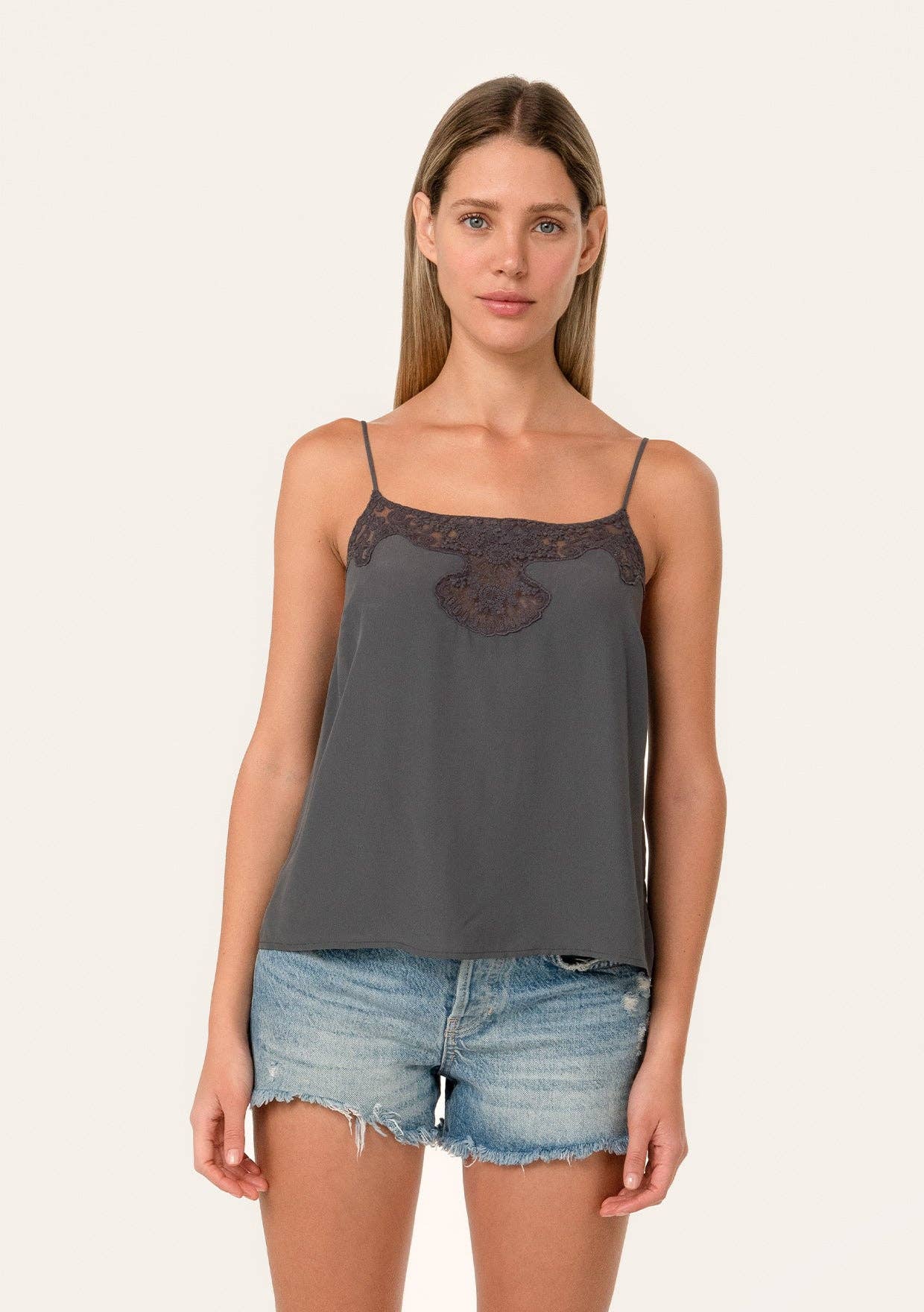 Woman wearing a gray Button Back Embroidered Lace Cami with thin straps and denim shorts against a neutral background