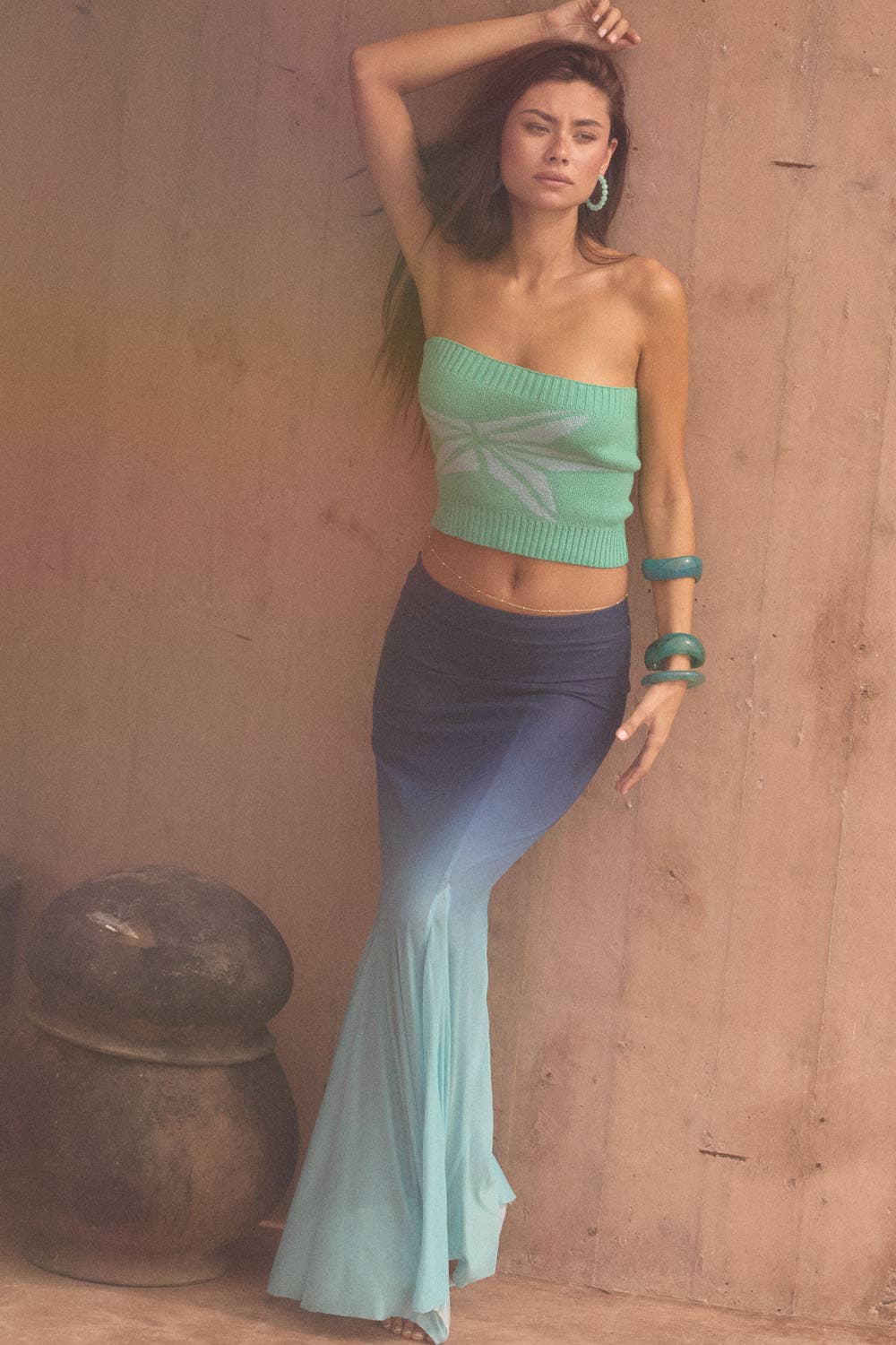 Woman wearing an Ombre Mesh Fit-and-Flare Godet Maxi Skirt with gradient blue shades styled with turquoise accessories