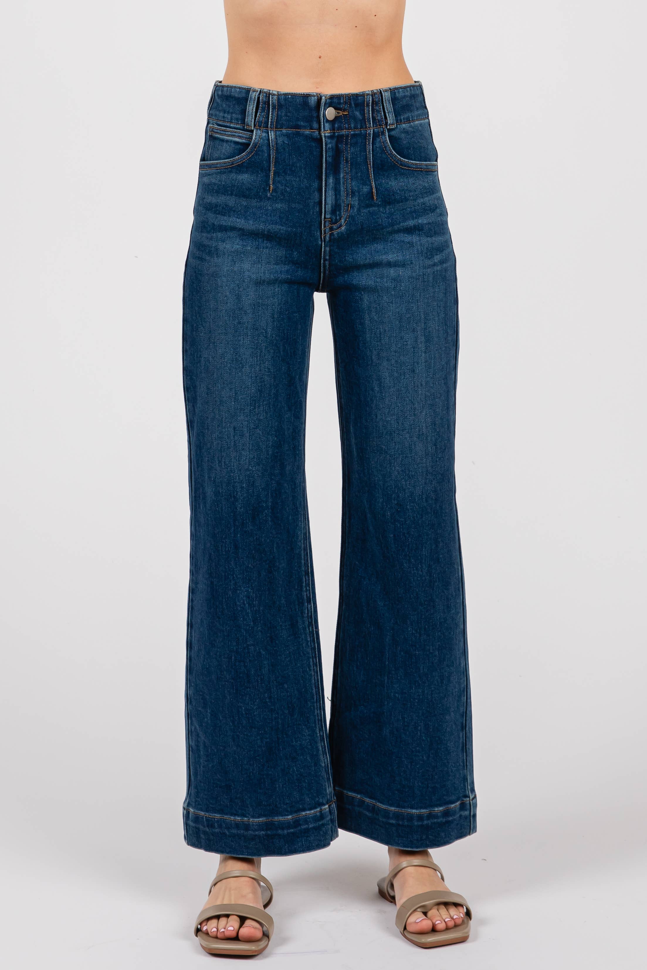 A person in L.T.J Letter to Juliet Dart Detail Wide Crop Jeans in dark blue, paired with beige open-toe sandals, stands against a plain white background. Only the lower torso and legs are visible.
