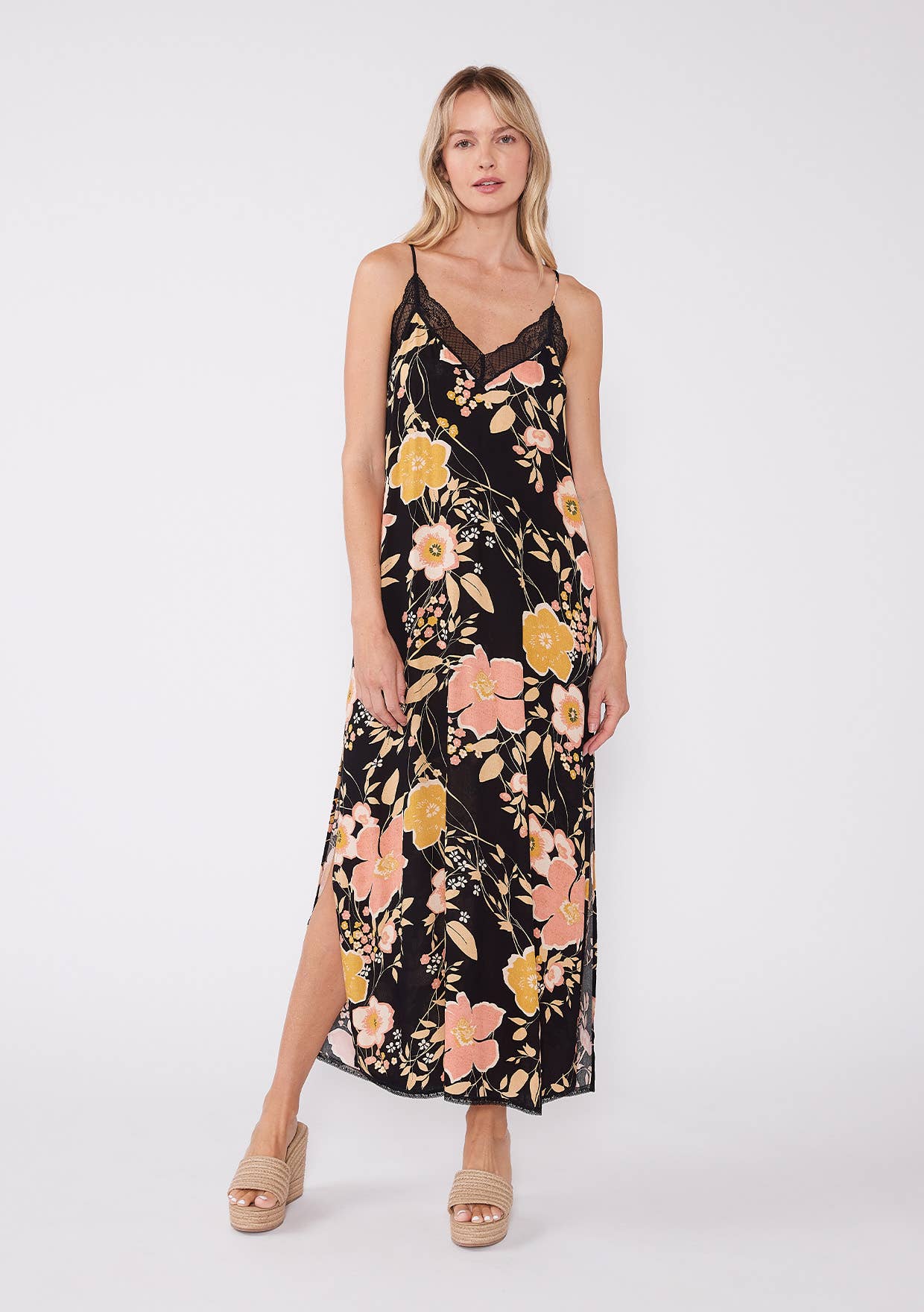 Woman wearing Floral Lace Trim Racerback Maxi Dress with large peach and yellow flowers on black background