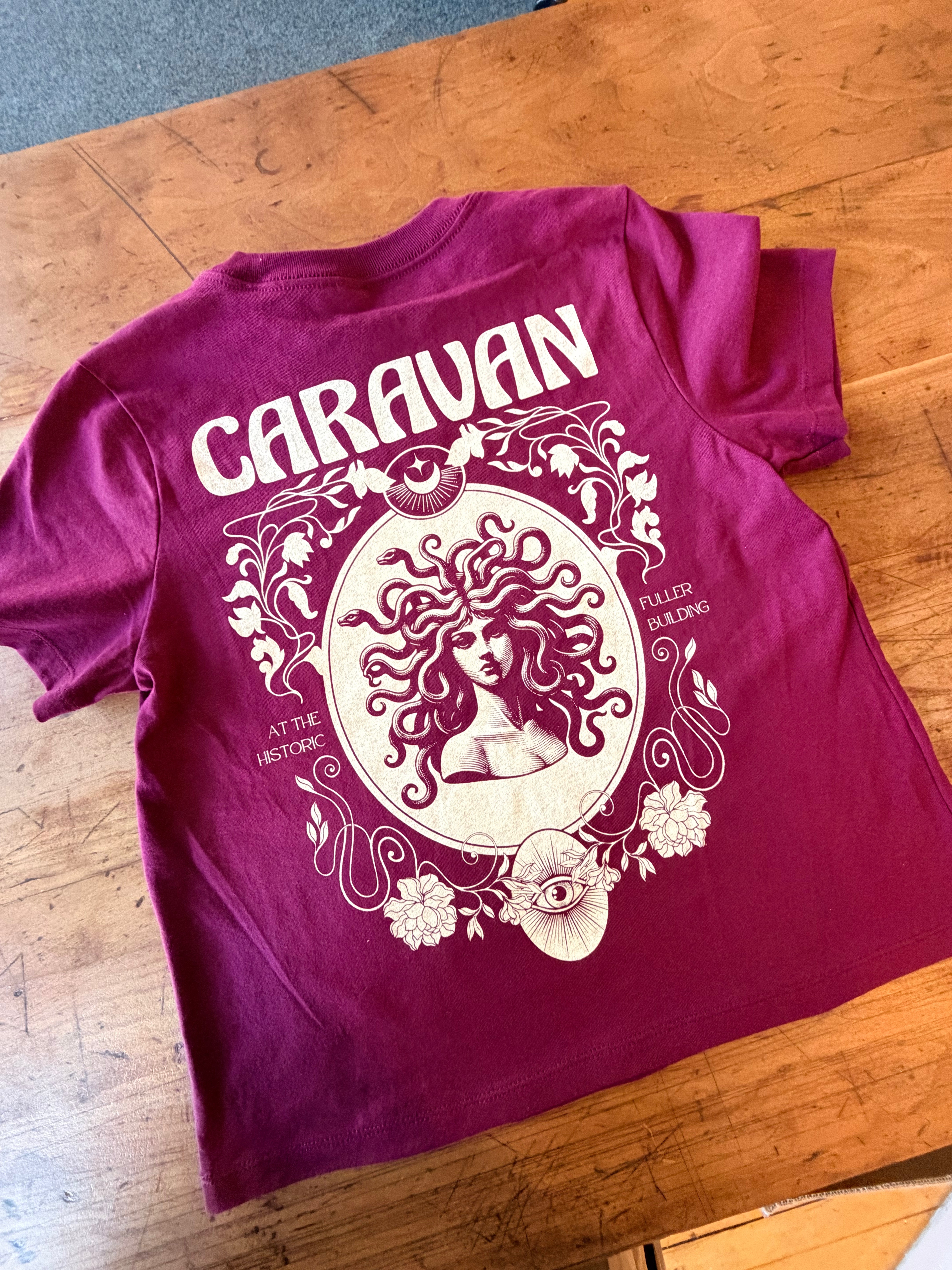 Caravan Legacy Tee in deep red with intricate vintage-inspired graphic of a woman surrounded by floral motifs.