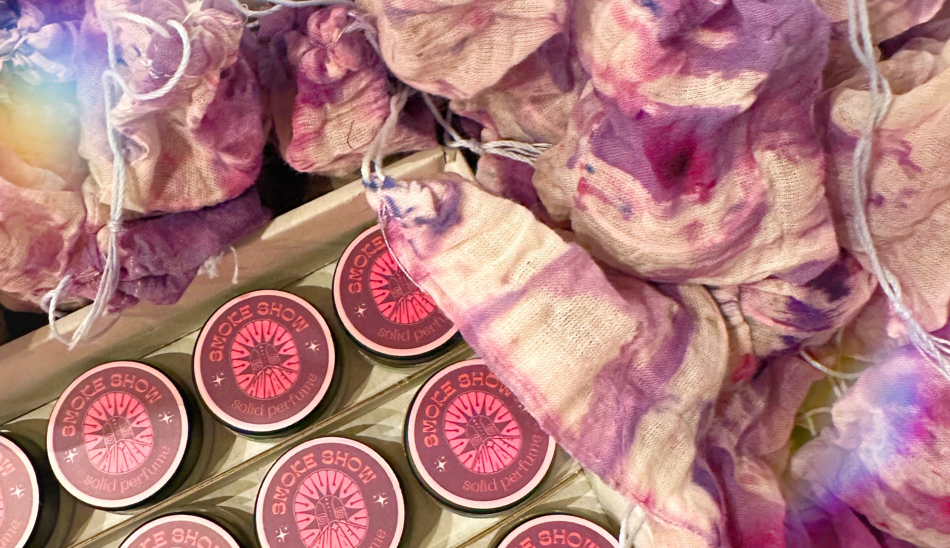 Pink lip balm tubes with decorative packaging on a table