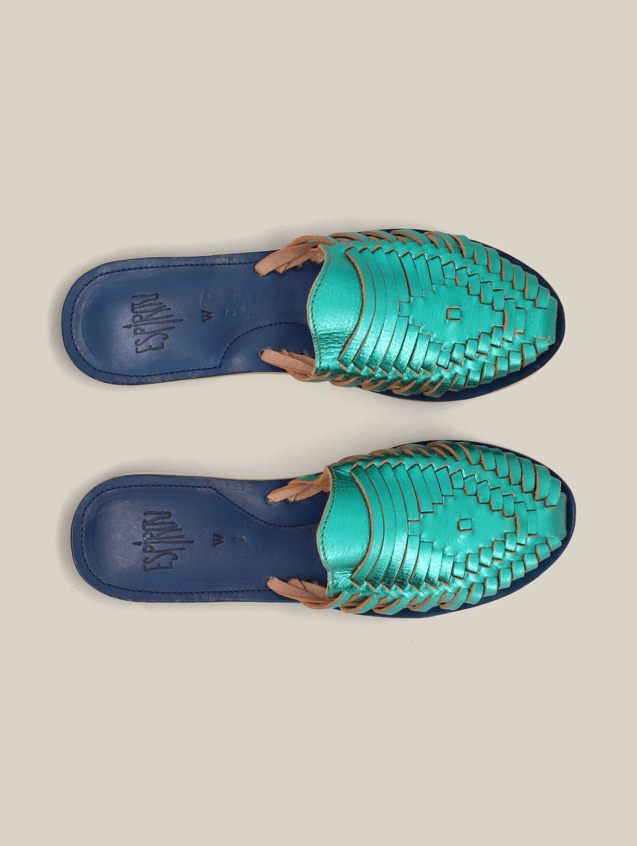 Emerald Slip On Huaraches featuring woven leather upper in vibrant green with navy blue cushioned footbeds