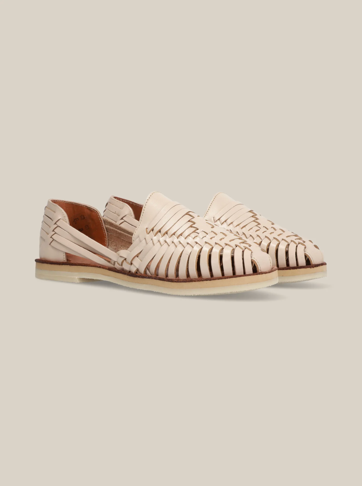 Desierto Classic Huaraches in natural leather with woven design and open sides on a light background
