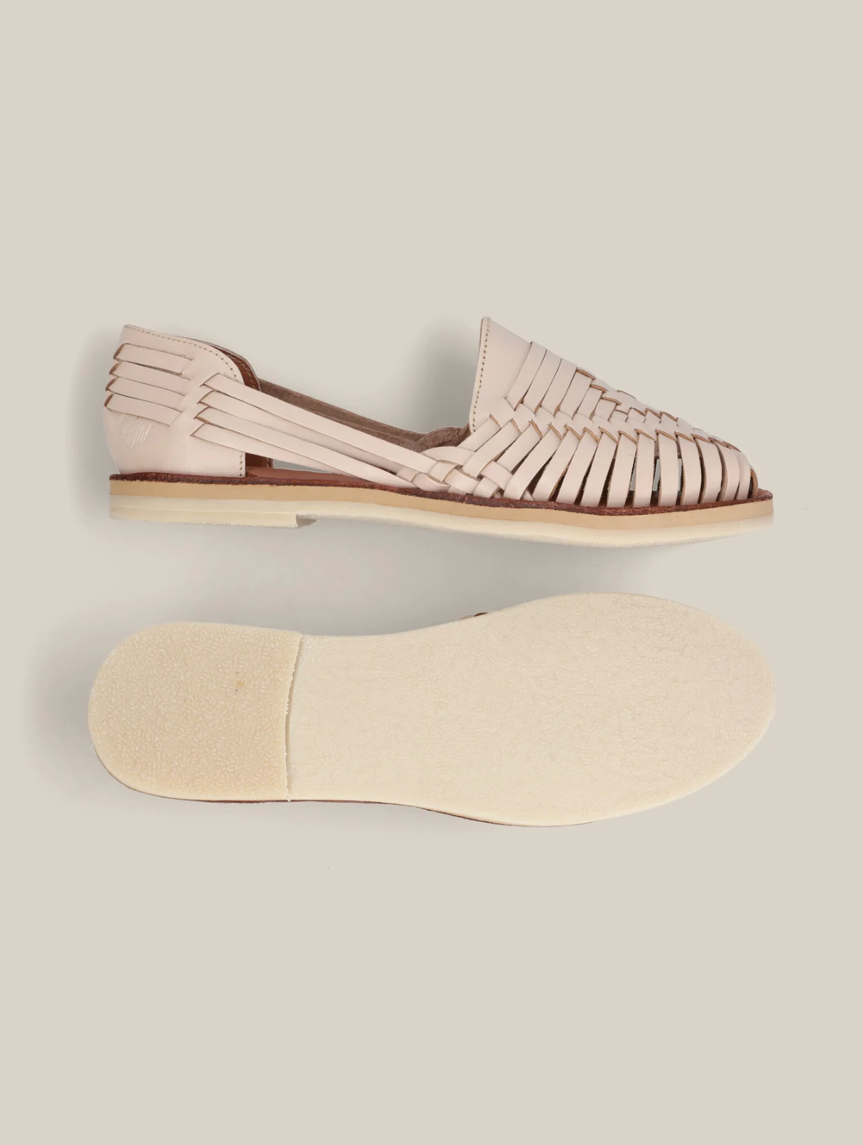 Desierto Classic Huaraches in soft beige leather with woven detailing and a flat, cushioned sole for comfortable wear