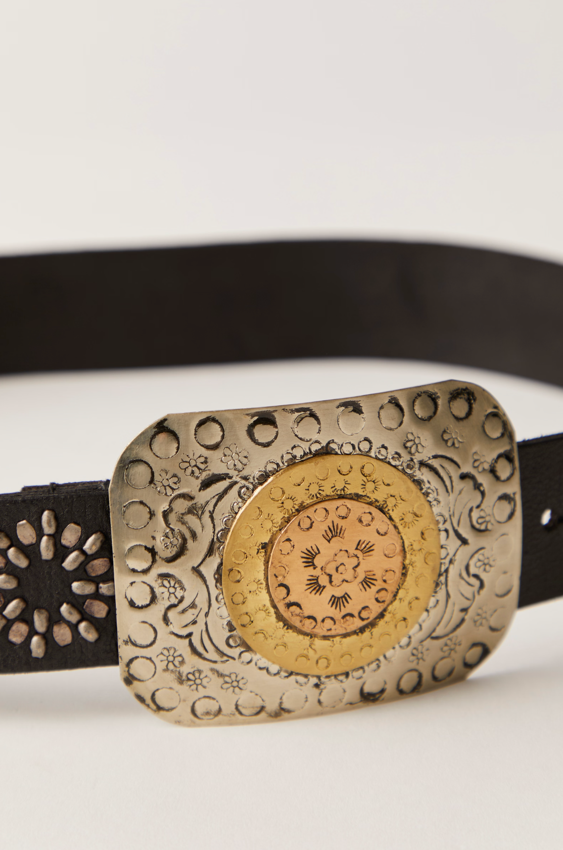 Roman Holiday Belt with ornate brass buckle featuring intricate floral and circular engravings on black leather strap