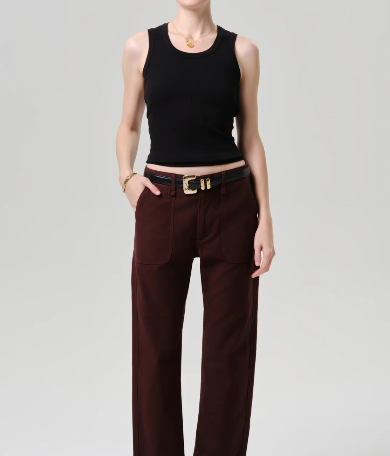 Model wearing The Nova Tank by Citizens of Humanity in Black paired with high-waisted dark brown pants and accessories