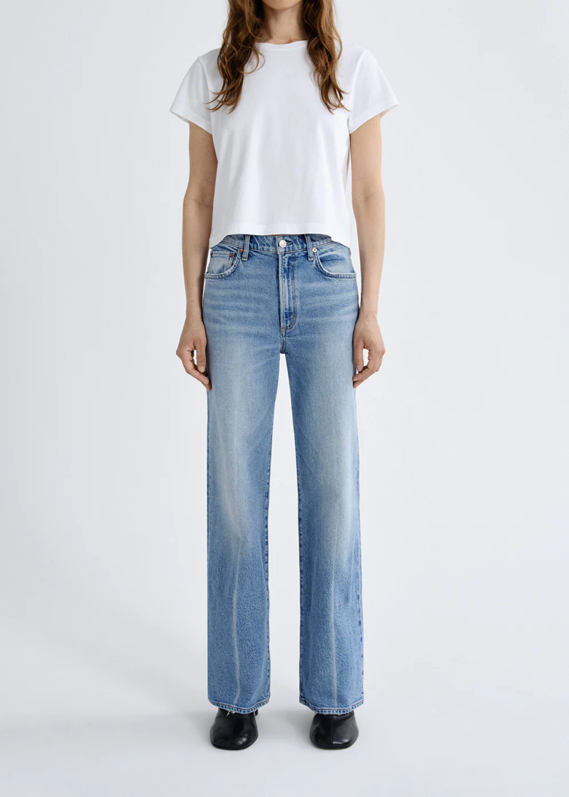 Front view of a woman wearing The Harper Jean in Outlook by Agolde paired with a white cropped T-shirt and black shoes