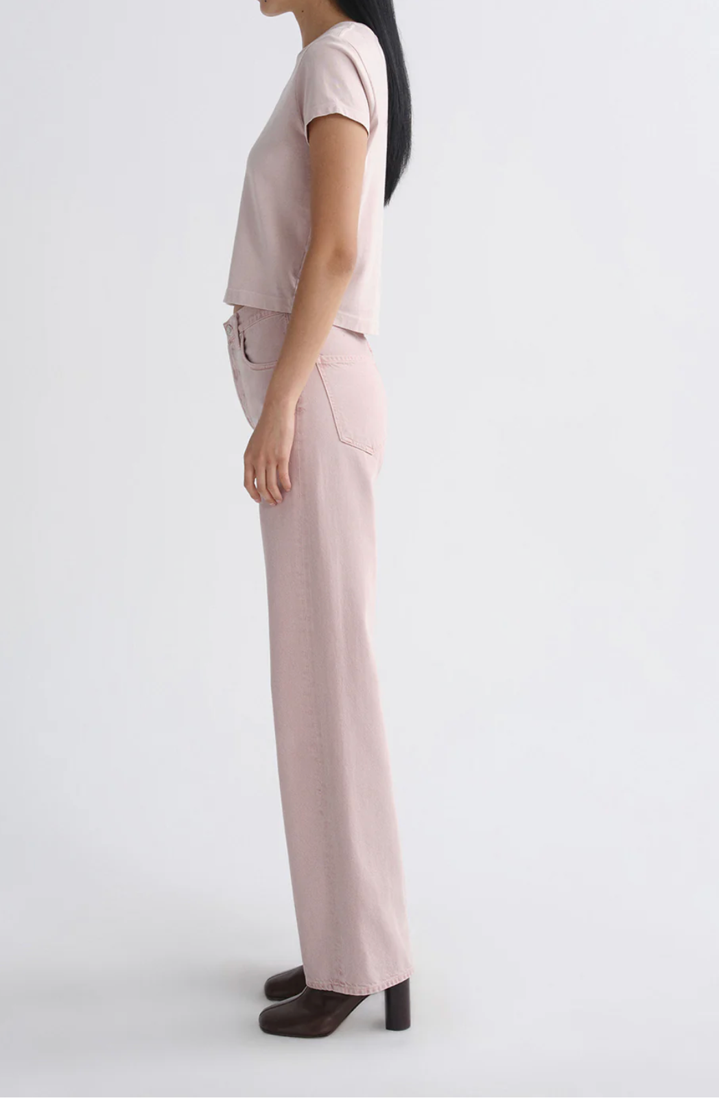 Side profile of a model wearing The Adine Shrunken Te in Wallflower by AGOLDE paired with heeled boots