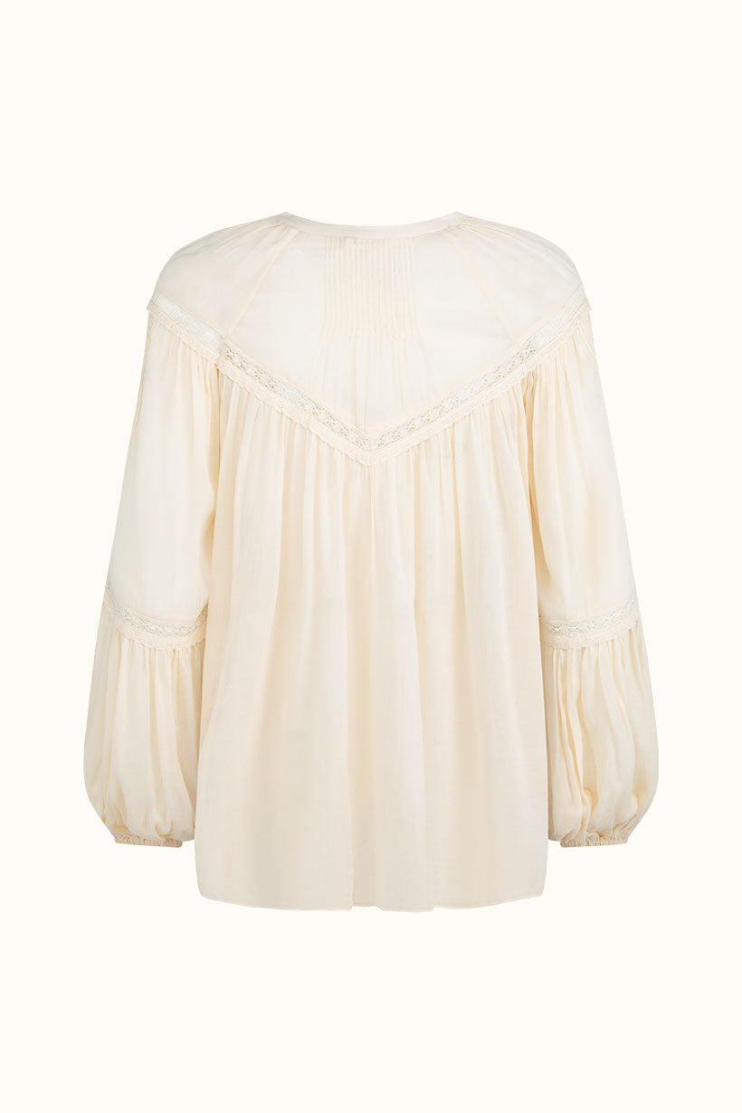 The Teodora Blouse - White Smoke by Spell features a loose fit, gathered fabric, lace trim, and a V-shaped back seam. Made from sustainable LENZING ECOVERO Viscose and shown on a plain light background.