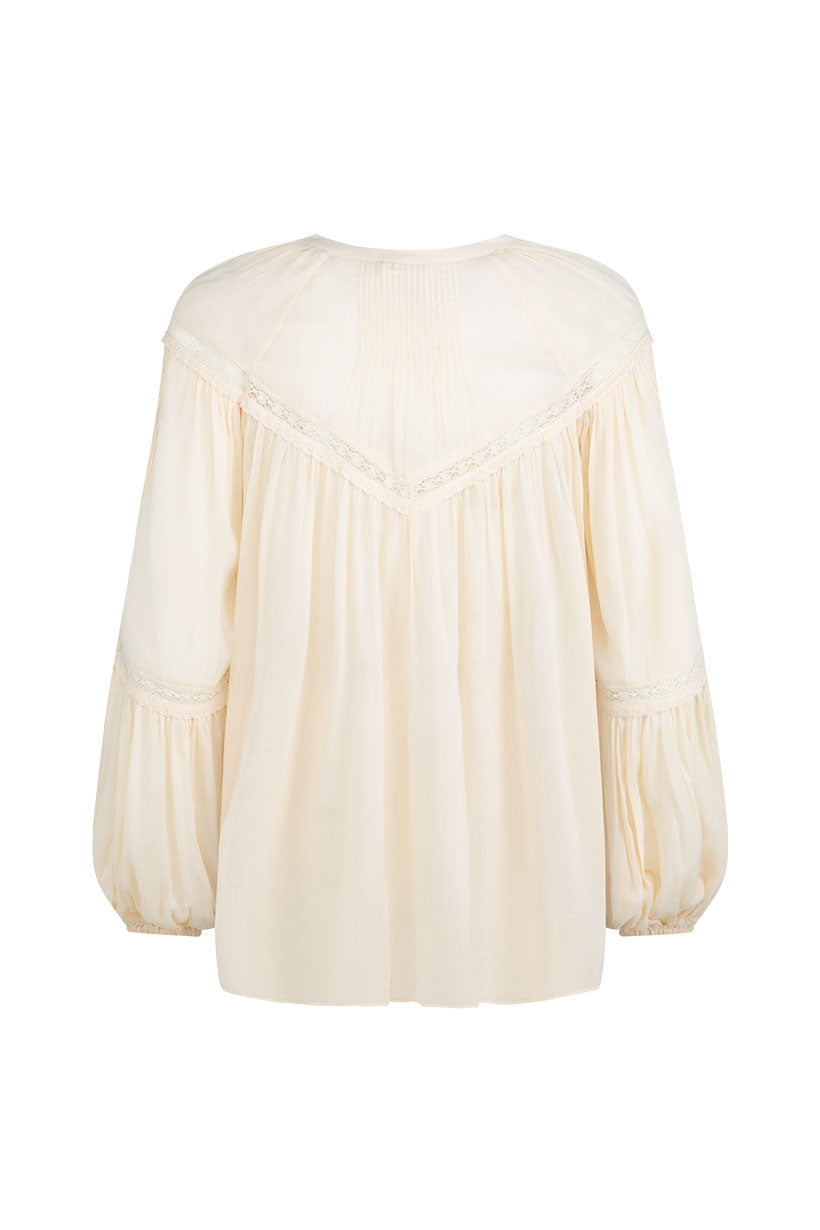 The Teodora Blouse - White Smoke by Spell features long gathered sleeves, a loose fit, lace trim, and subtle back pleating. Made from LENZING ECOVERO Viscose and Organic Cotton. Shown from the back.