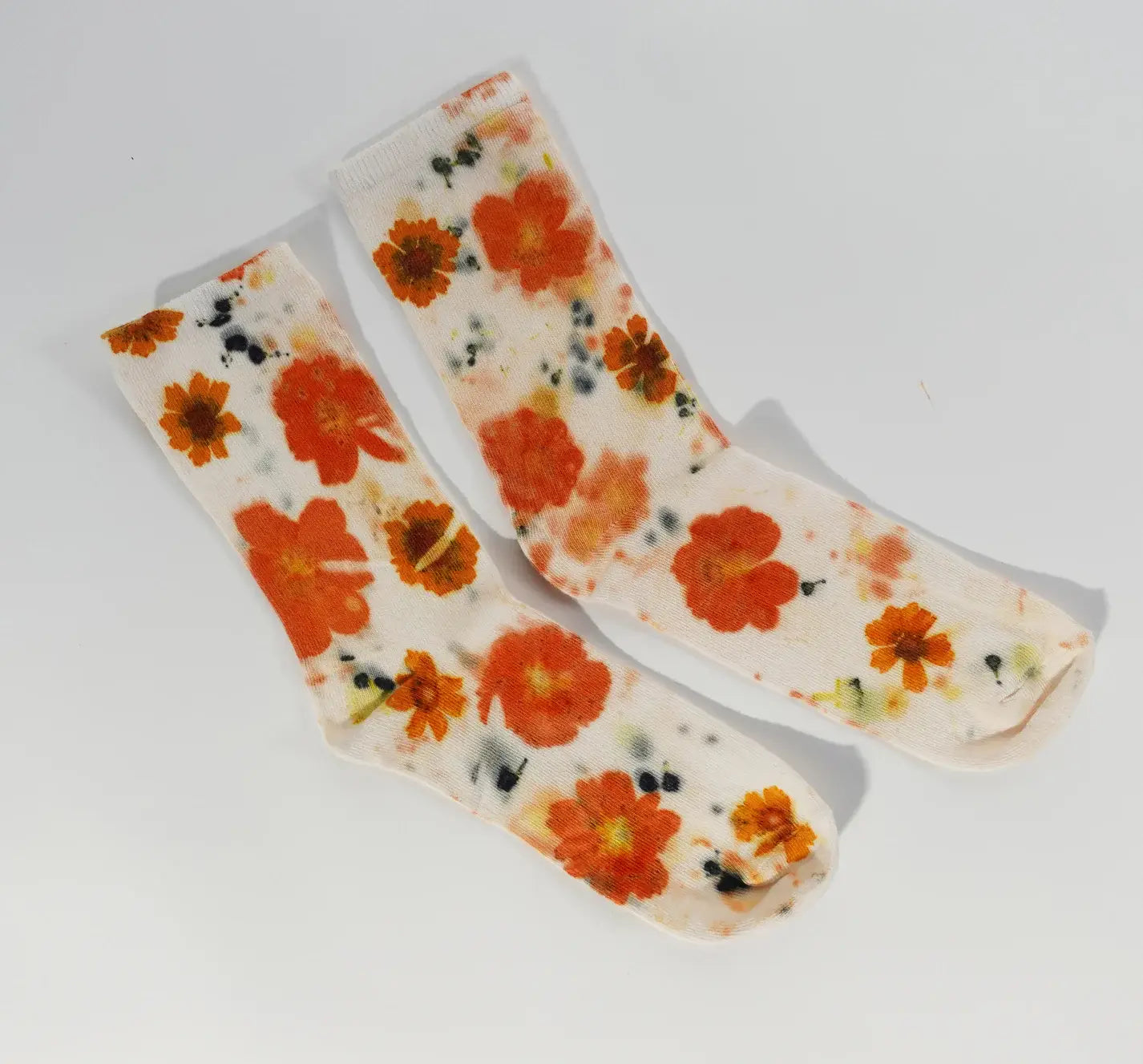 Pair of Flower Power Cotton Crew Sock with bright orange floral pattern on soft white cotton fabric