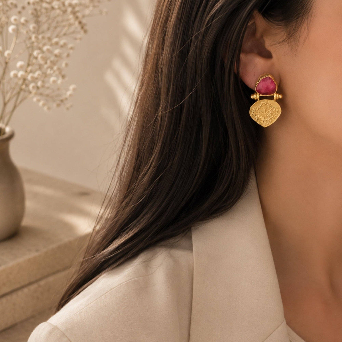 Ayda Ruby Earrings with ruby and gold textured drop design worn on ear