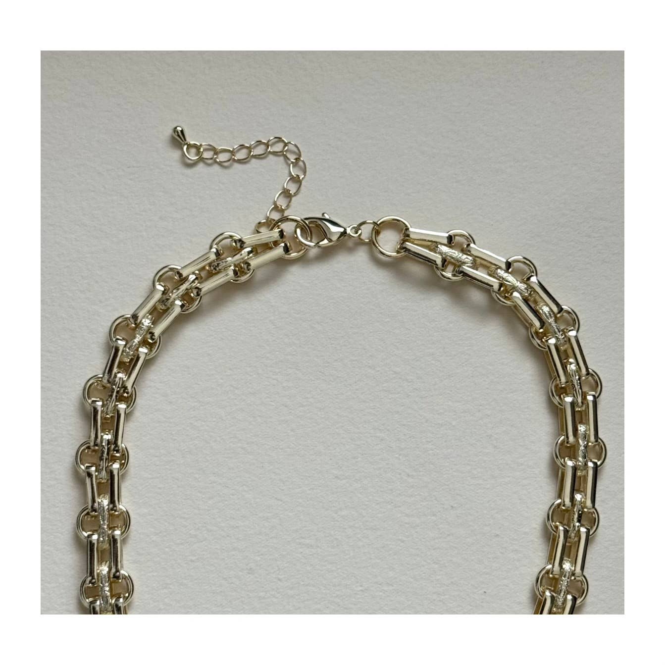 The Golden Nautilus Necklace by Tramps+Thieves features gold-filled round links and an adjustable extender clasp, shown on a neutral background—an elegant piece of coastal jewelry to elevate your style.