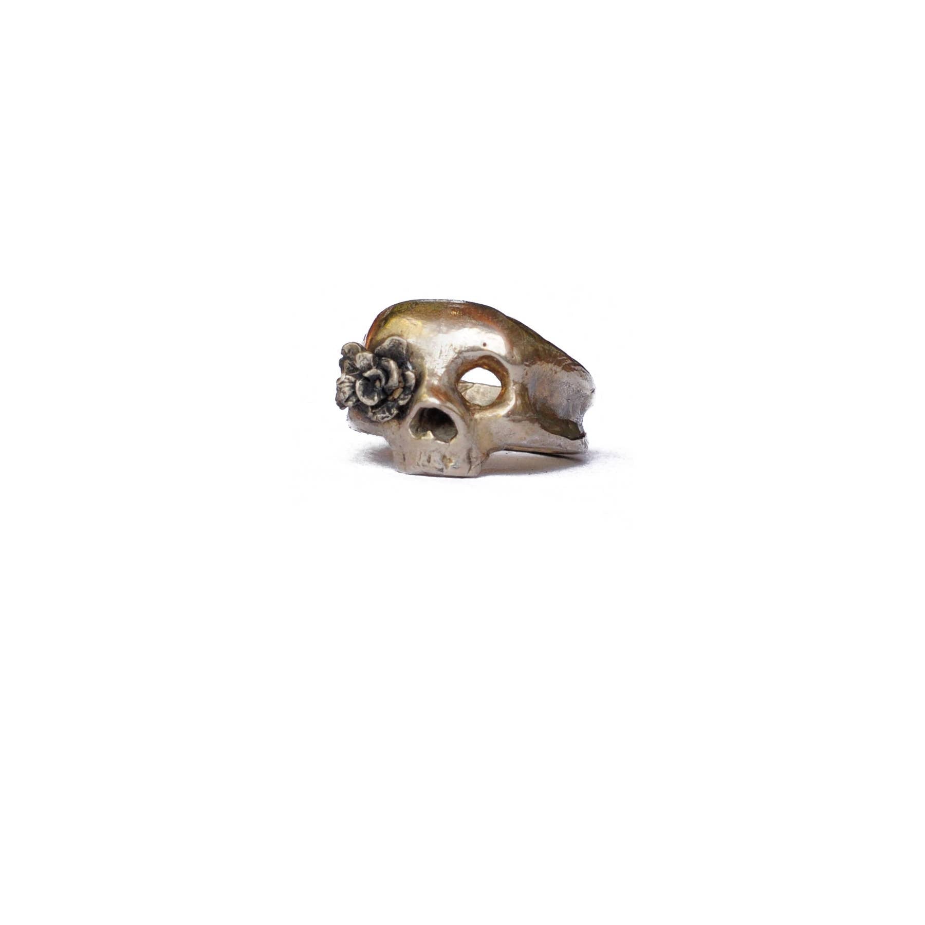ARTEMIS ring featuring a skull design with a floral detail, showcasing artisan craftsmanship and unique style