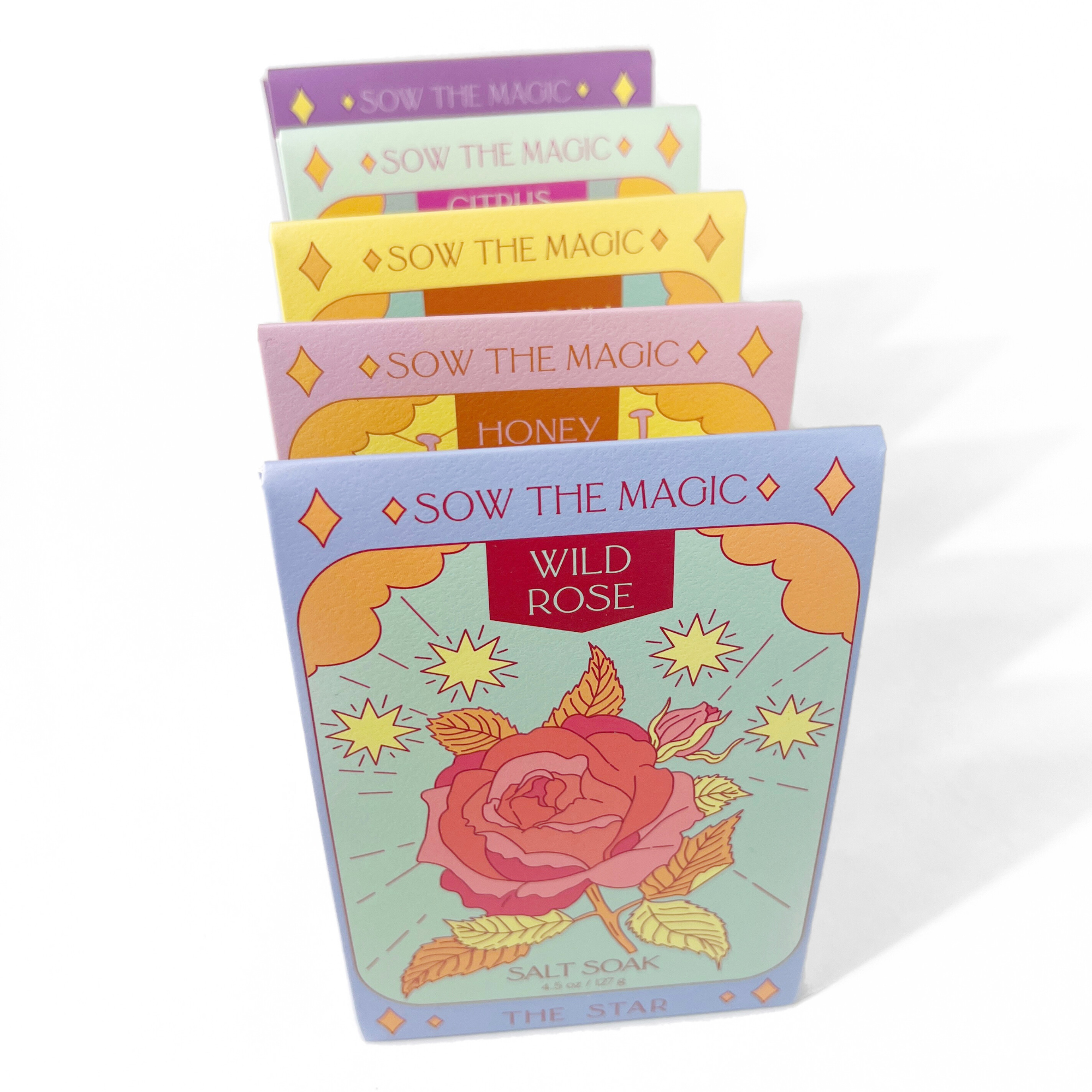 Strength Salt Soak in Citrus Echinacea displayed among colorful, artistic packaging with floral and mystical designs on white background