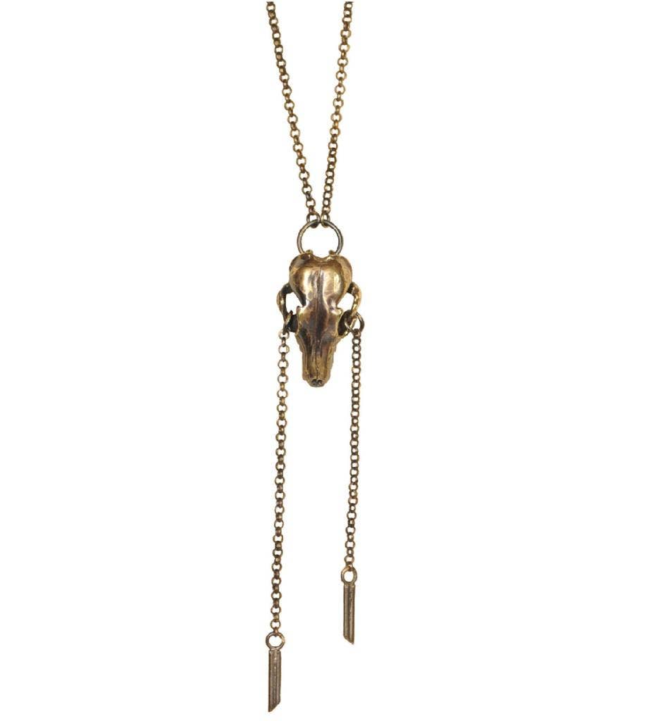 The Antique Brass Fox Skull Pendant Necklace by Monica Wallway for Jan Hilmer + Sparrow features a handcrafted animal skull pendant and two long chains with rectangular charms.