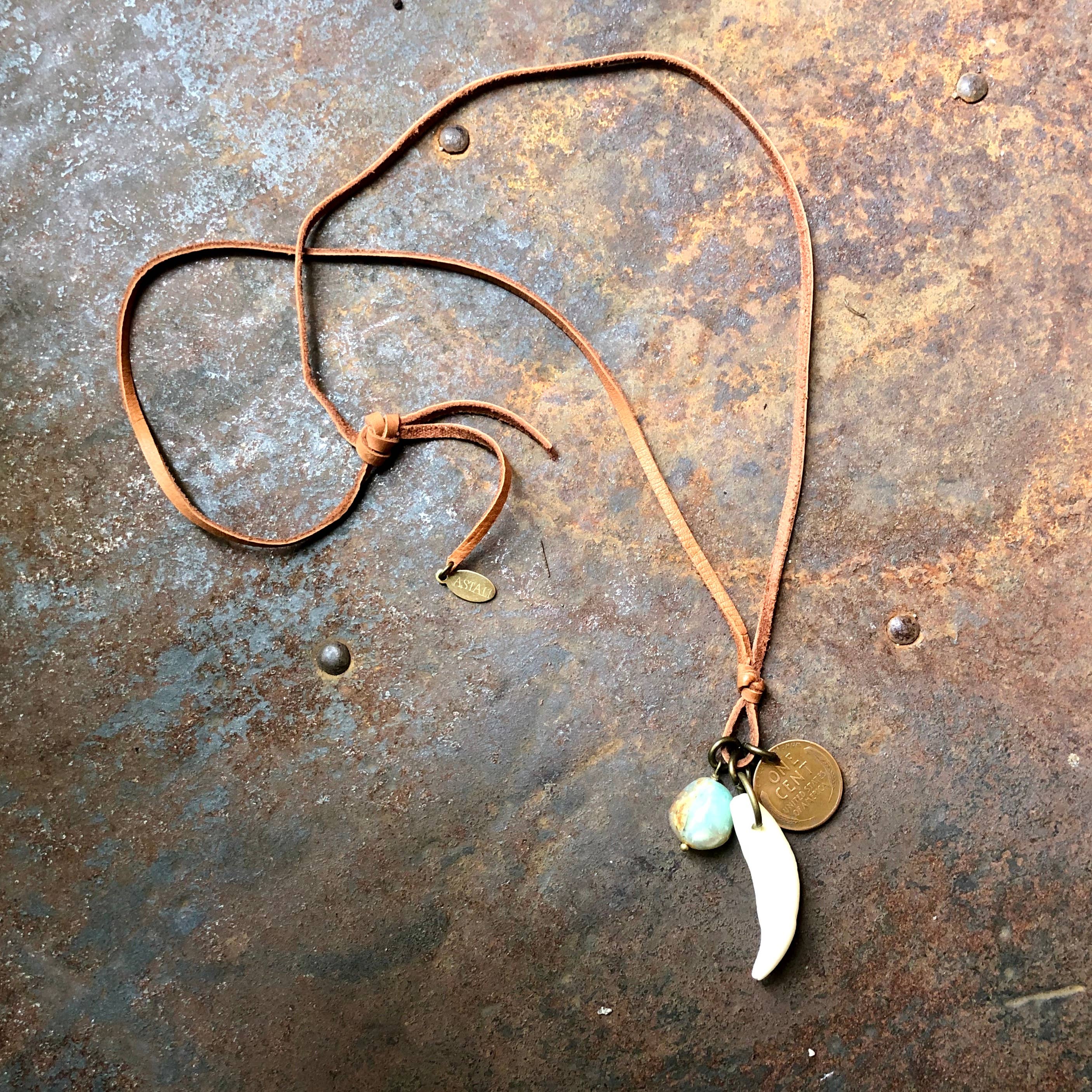 Coyote Tooth & Blue Opal Necklace, Wheat Penny, Rust Leather with natural charm pendants on a rustic background