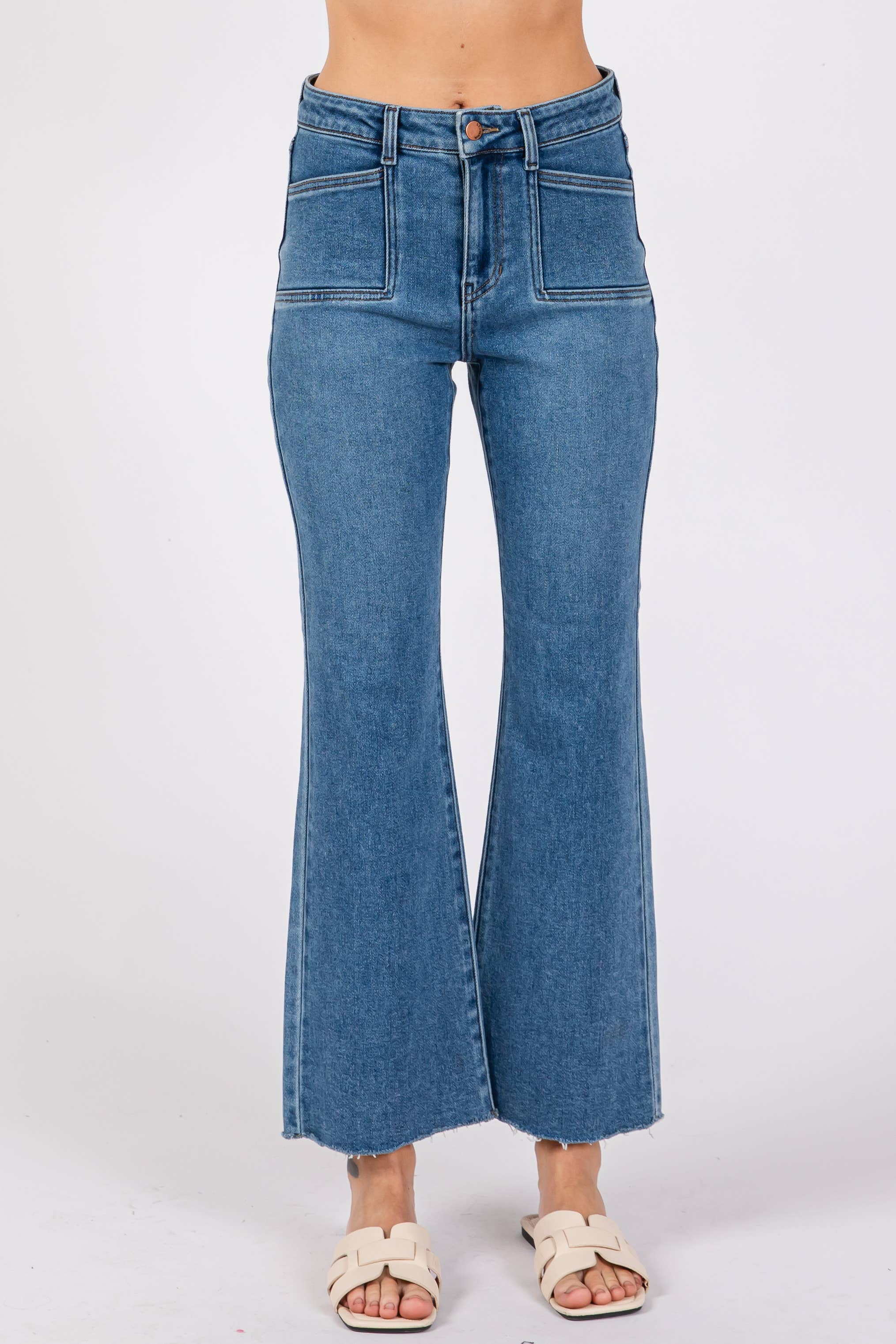 Front view of Medium Sicily Jean Square Pocket high rise wide leg denim jeans with raw hem on model.