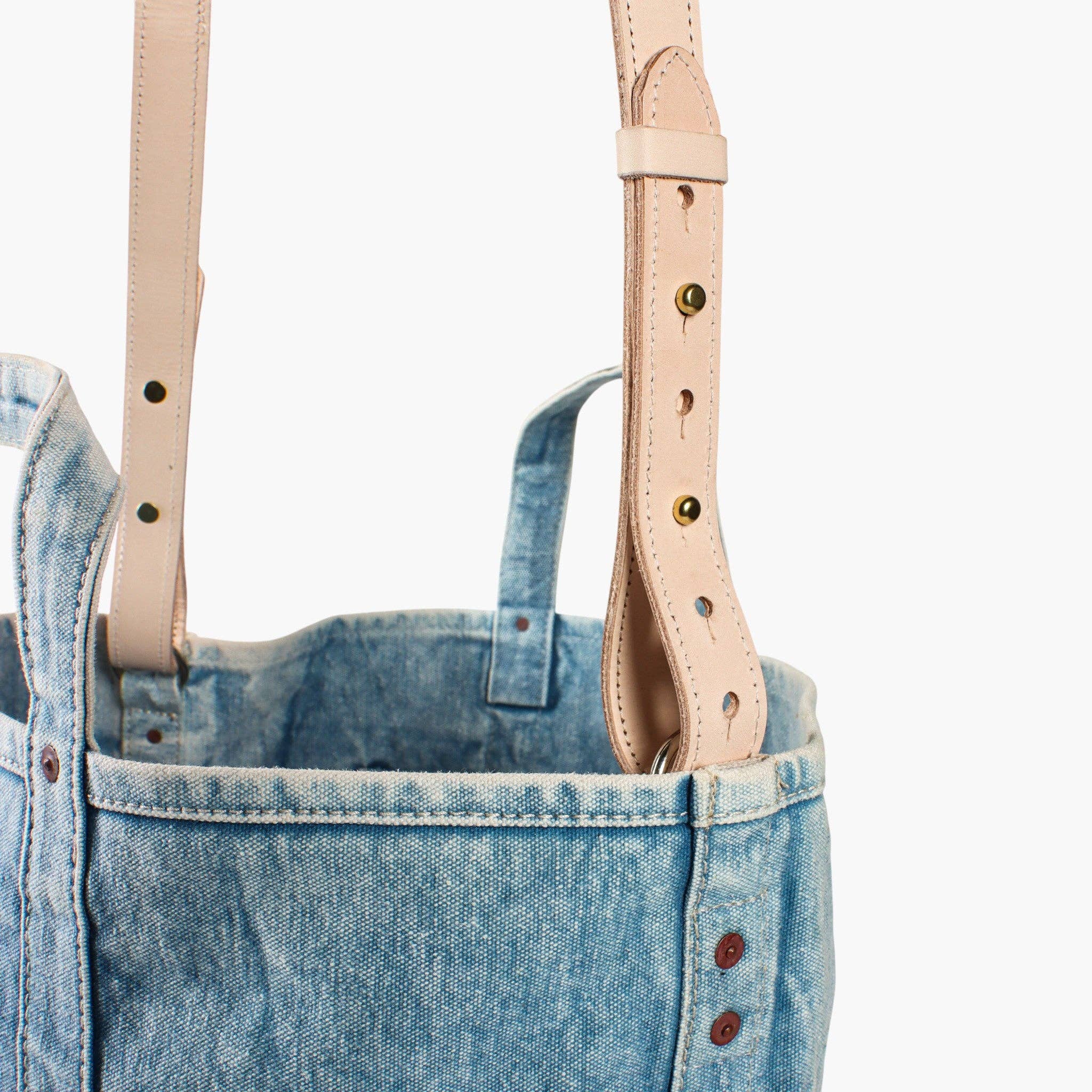 Close-up of soft leather straps and acid wash denim fabric on the Electrician Tote | Acid Wash bag