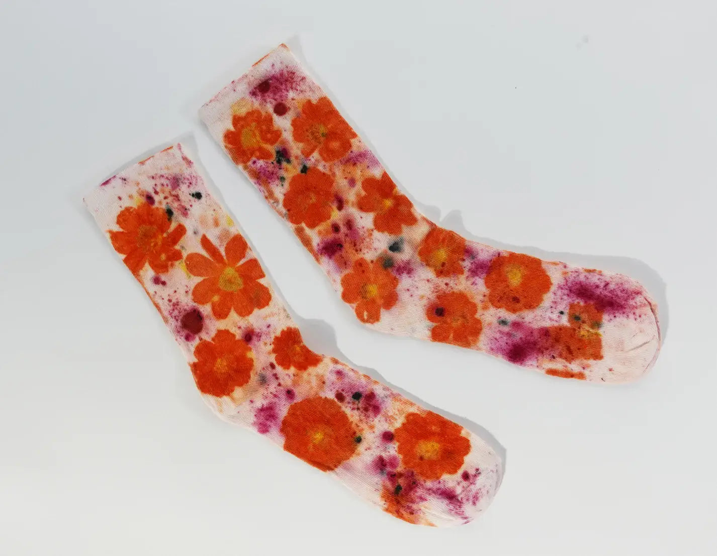 Pair of Flower Power Cotton Crew Sock with vibrant orange floral patterns on a soft white background